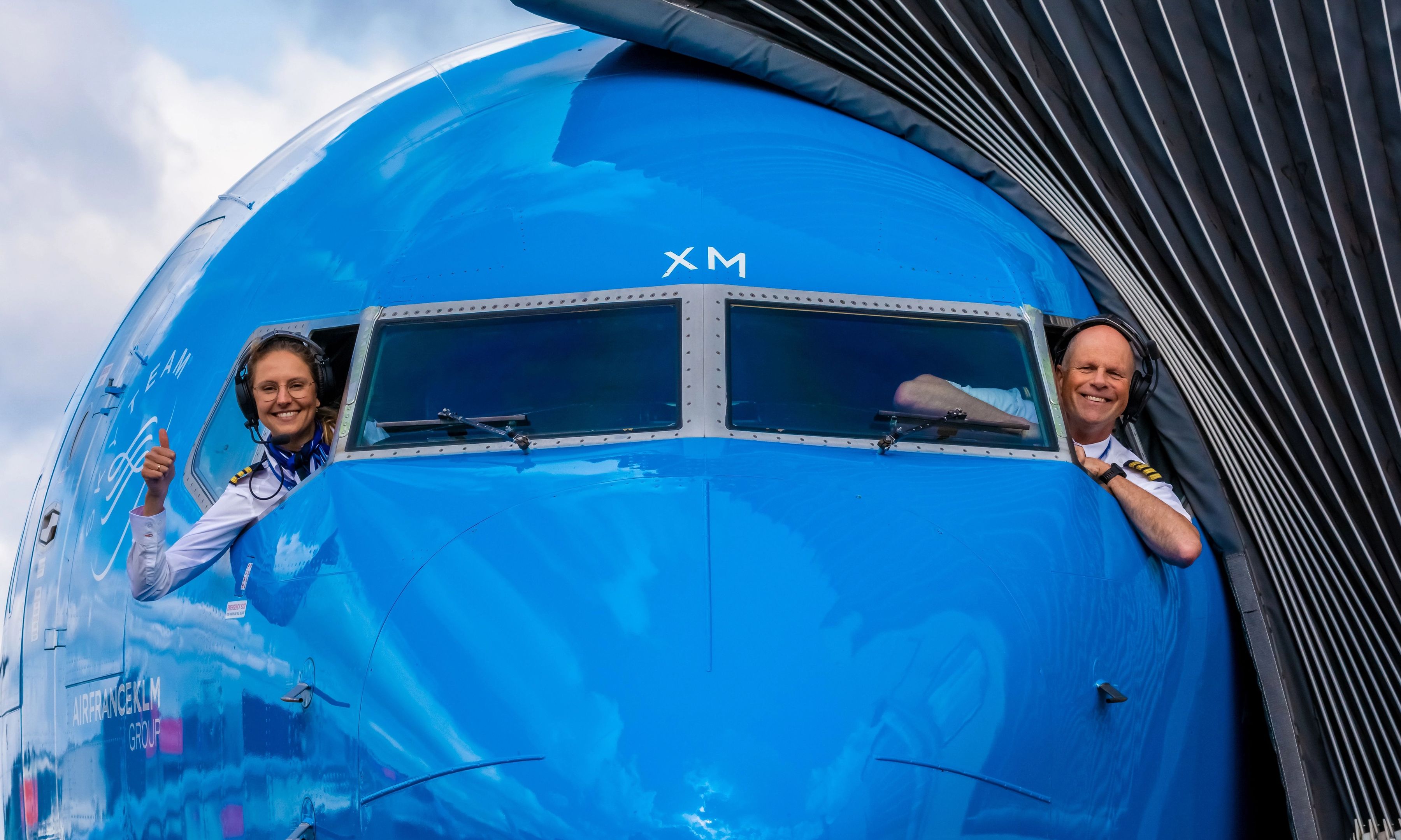 Two pilots looking out of the airplane window