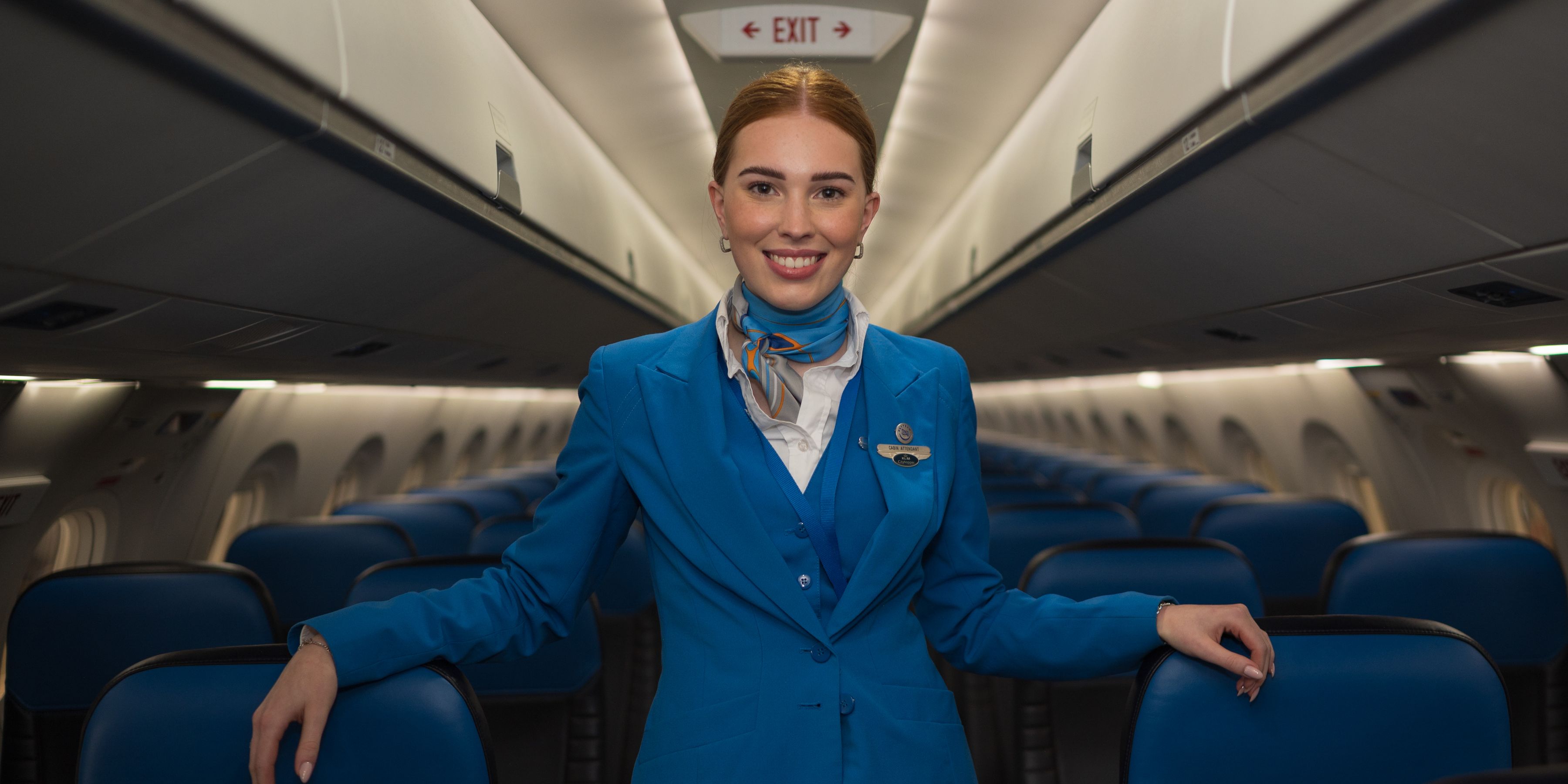 KLM Cityhopper cabin attendant standing in the middle of the aircraft