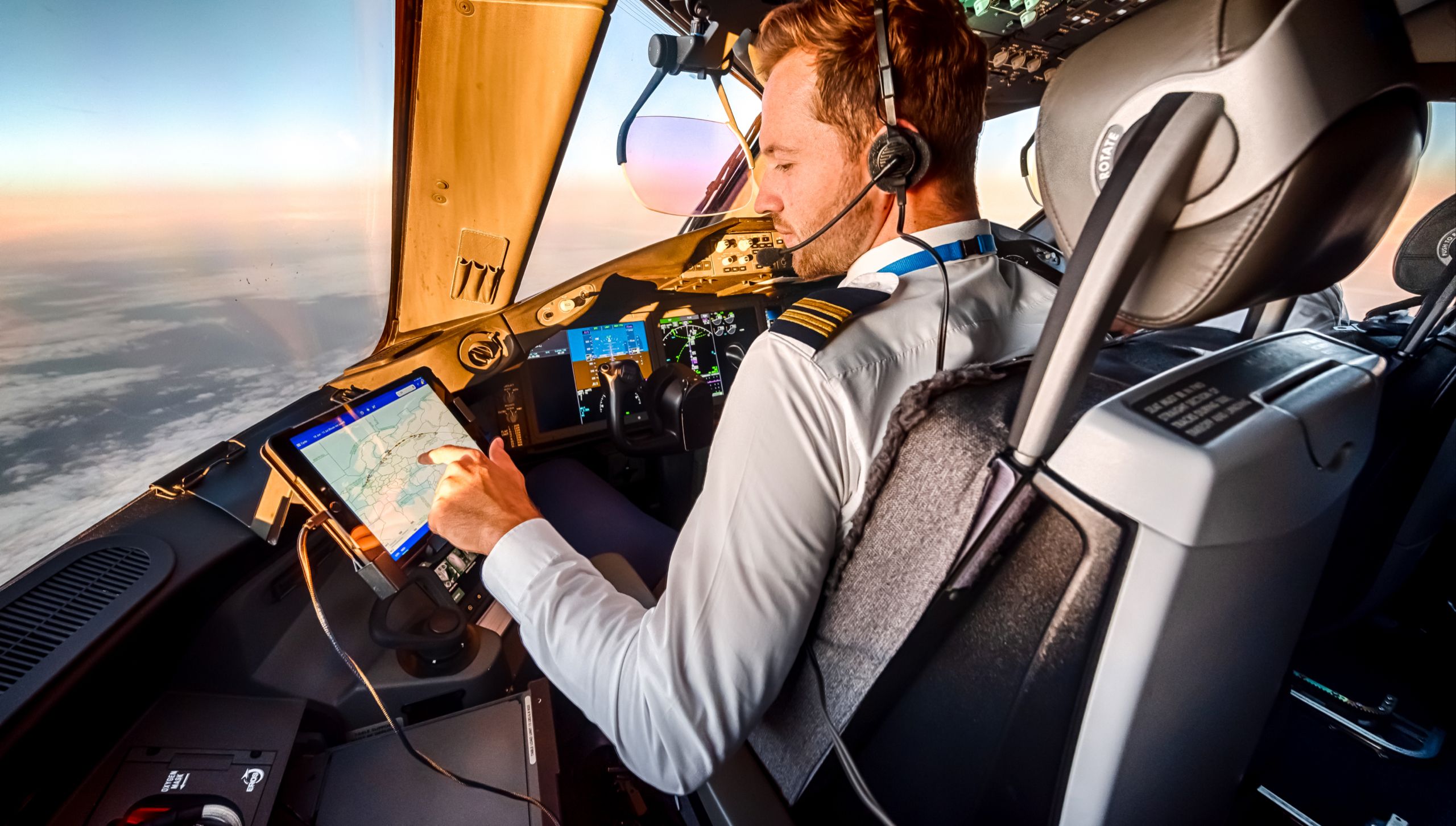 KLM pilot looking at a route on his Ipad midflight