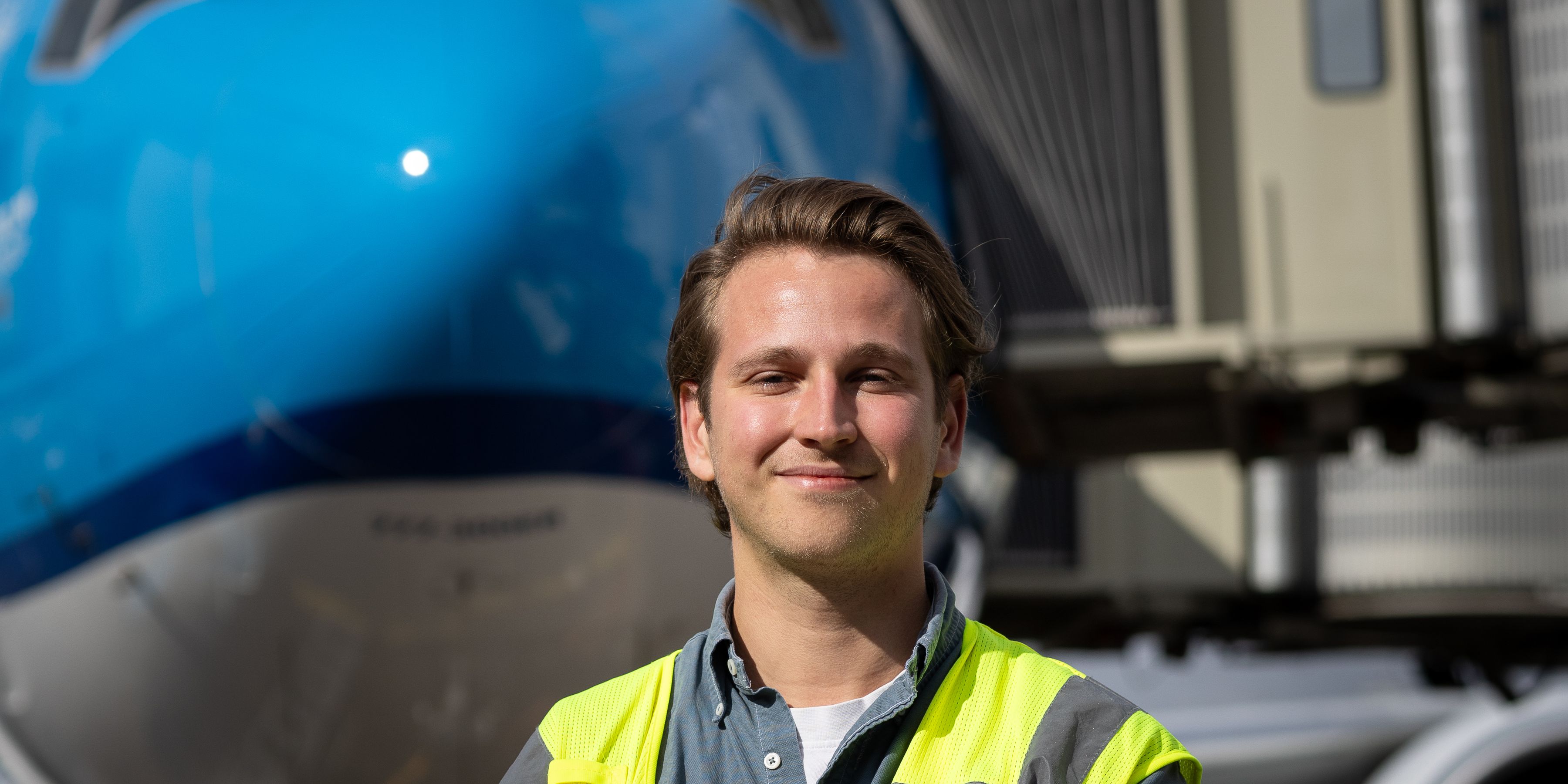 KLM colleague in front of the nose of an aircraft