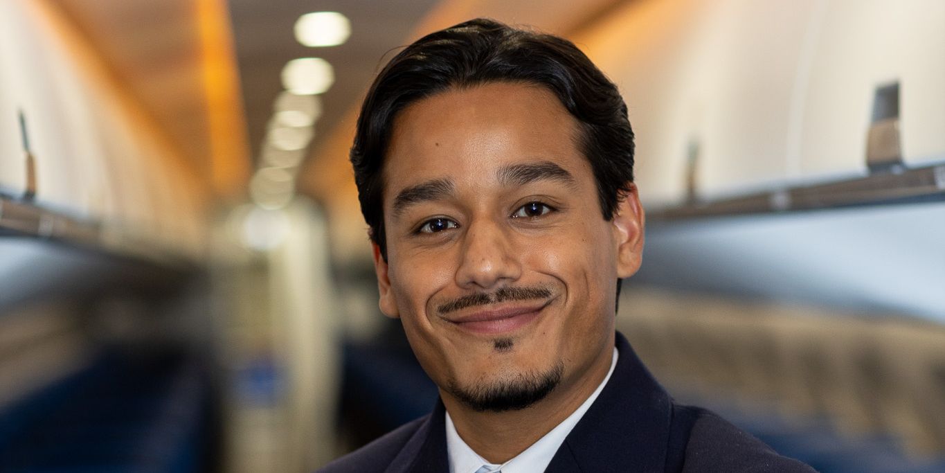 KLM Cityhopper cabin attendant staand in het midden van het vliegtuig