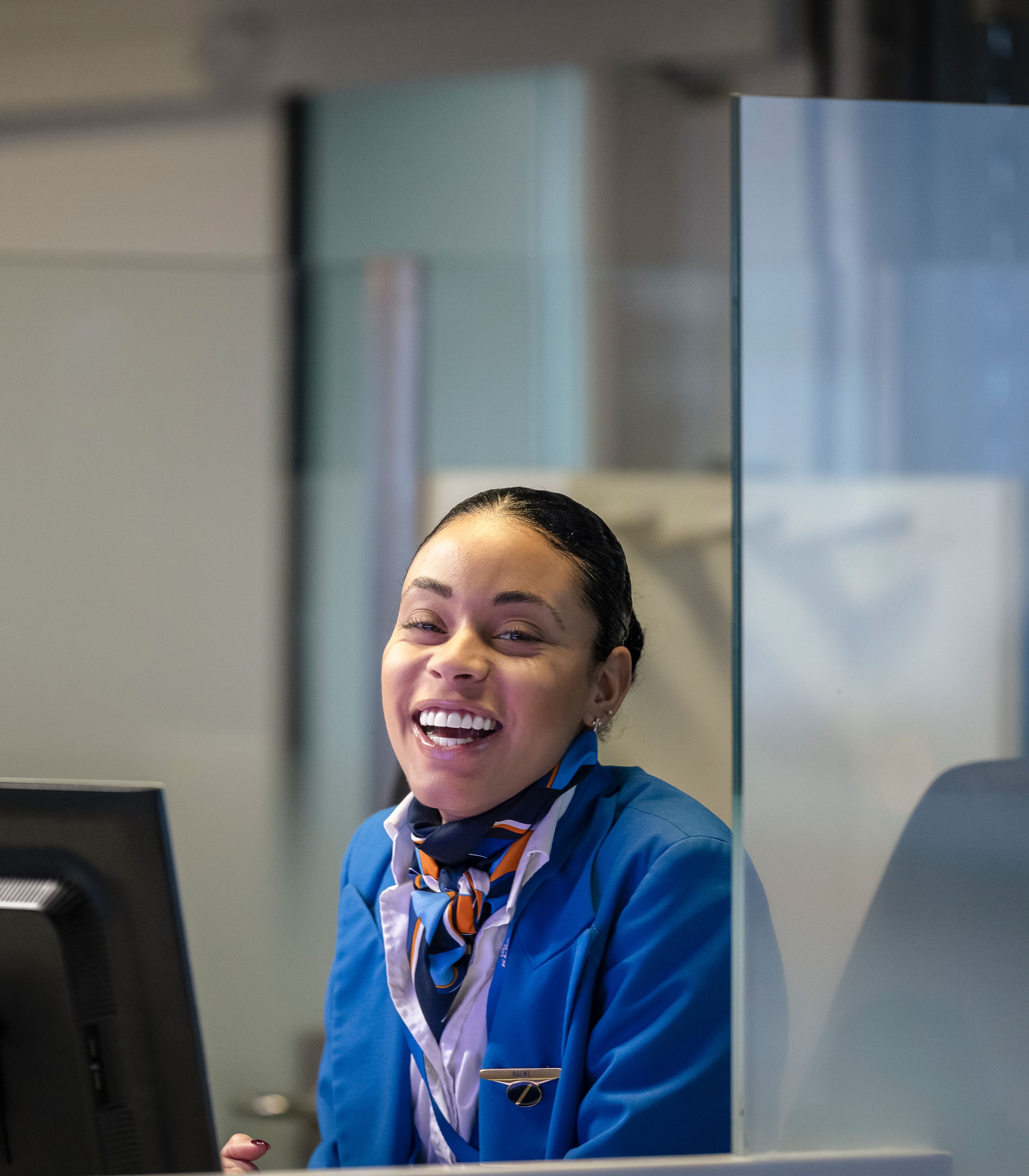 Een lachende service agent achter haar balie