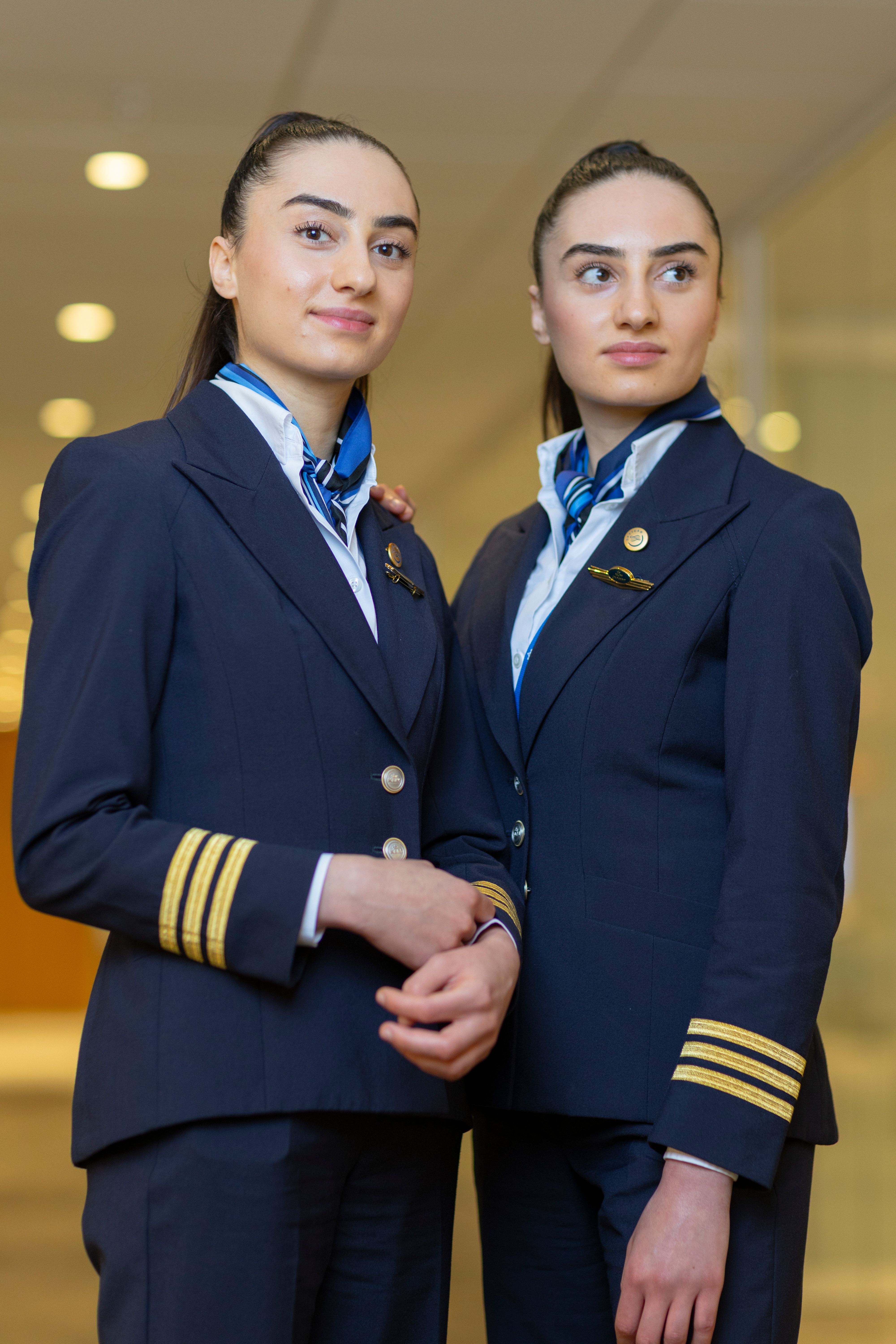 Two women twins in pilot uniforms