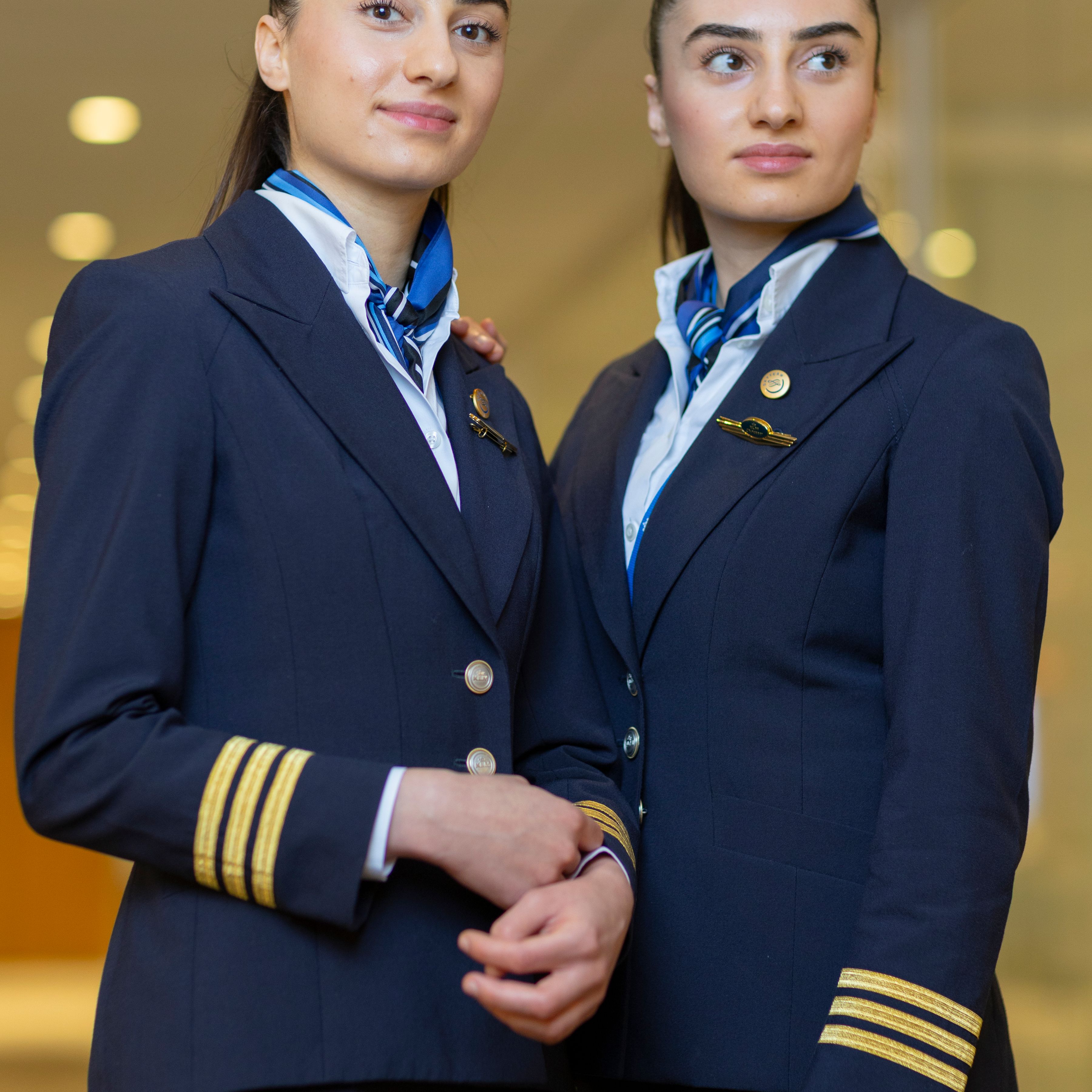 Two women twins in pilot uniforms