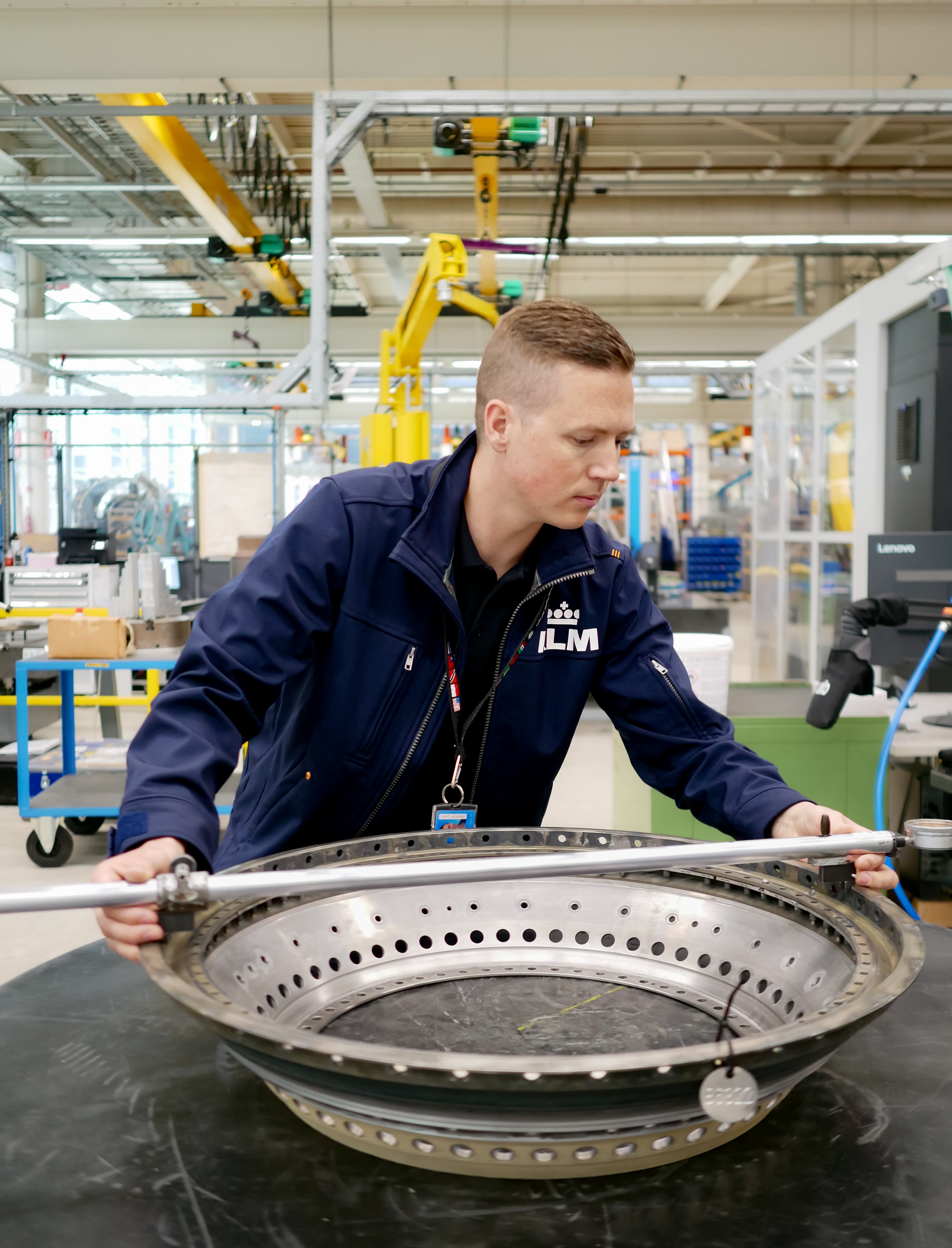 KLM collega werkt aan een vliegtuig onderdeel