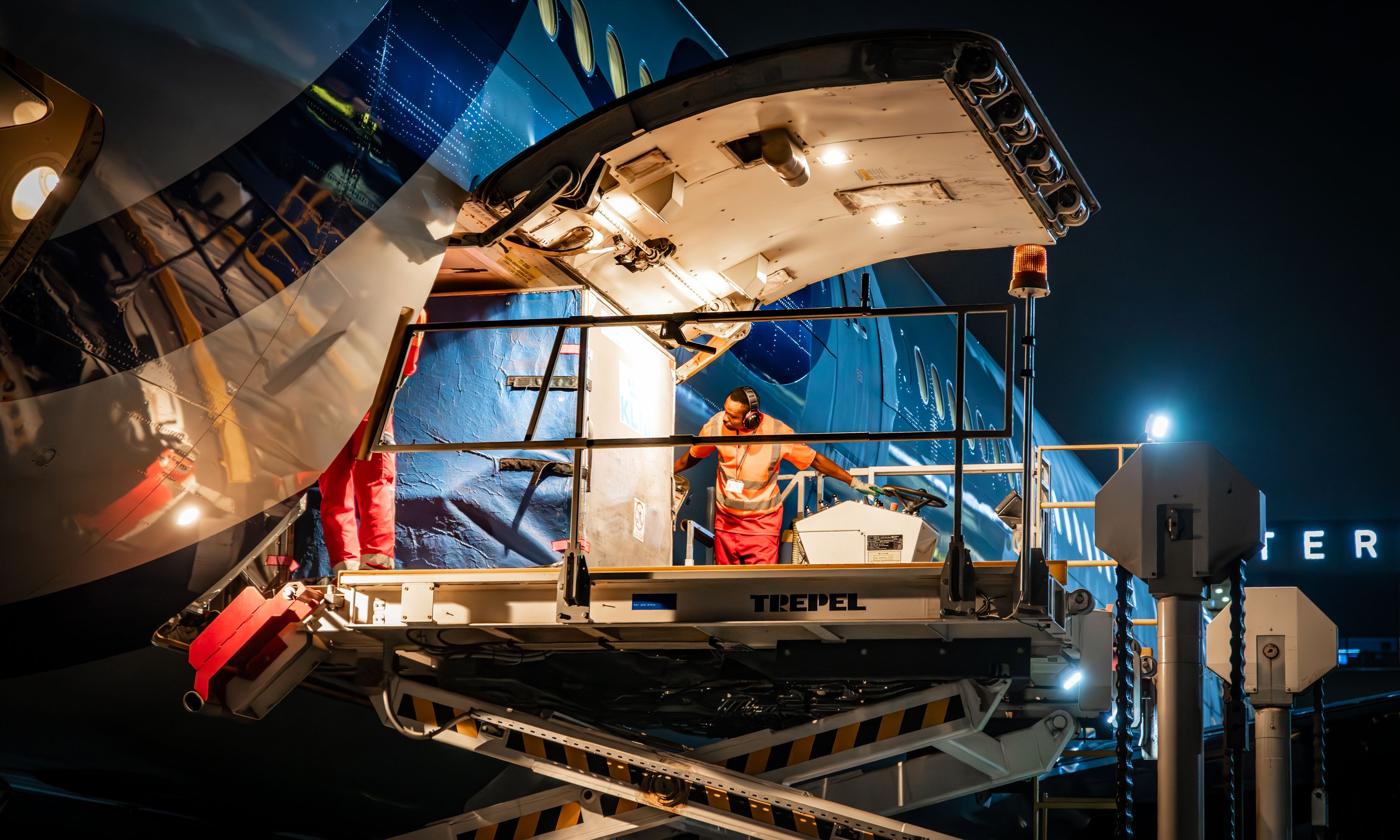 Loading freight on airplane at night