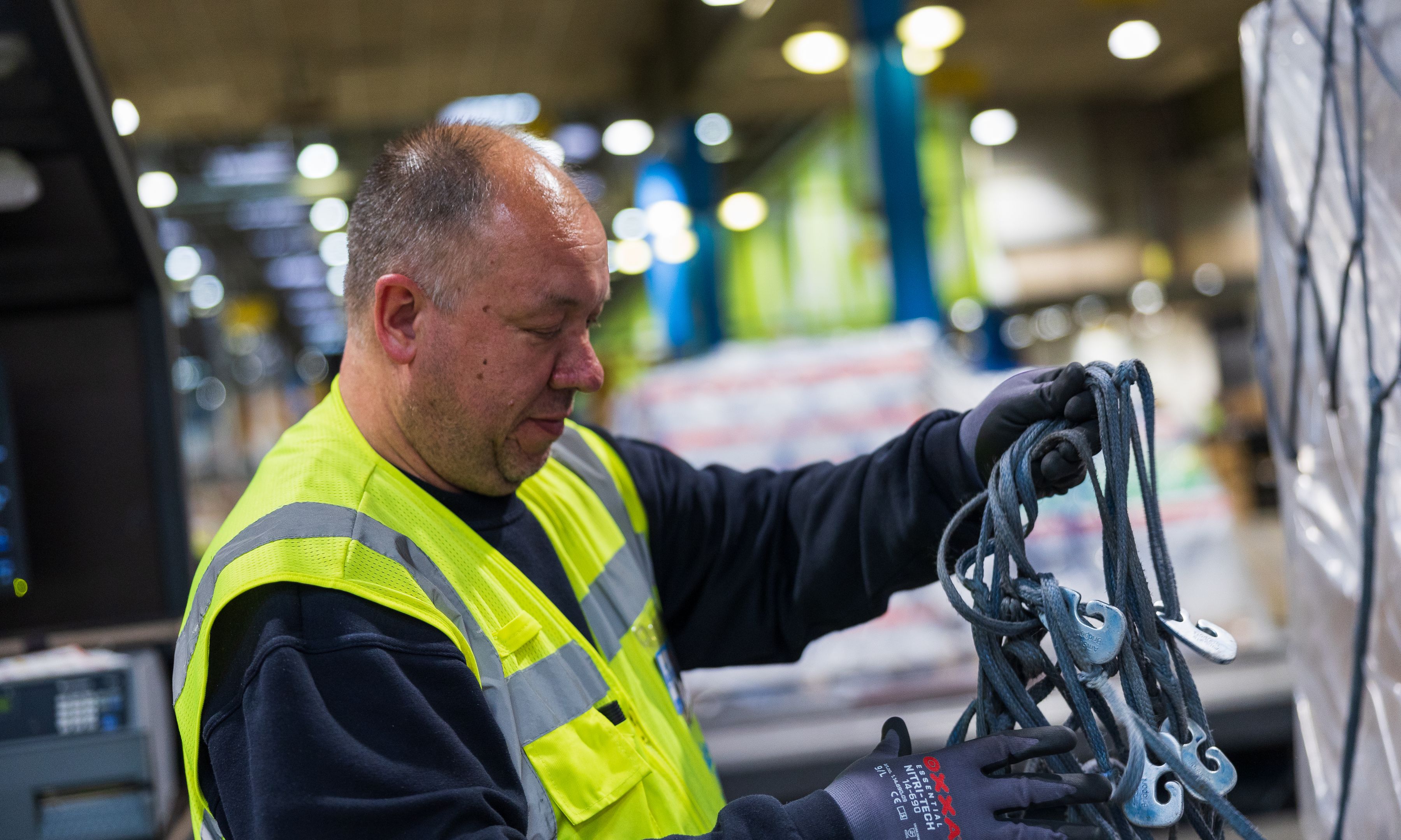 Employee prepares cargo for shipment.