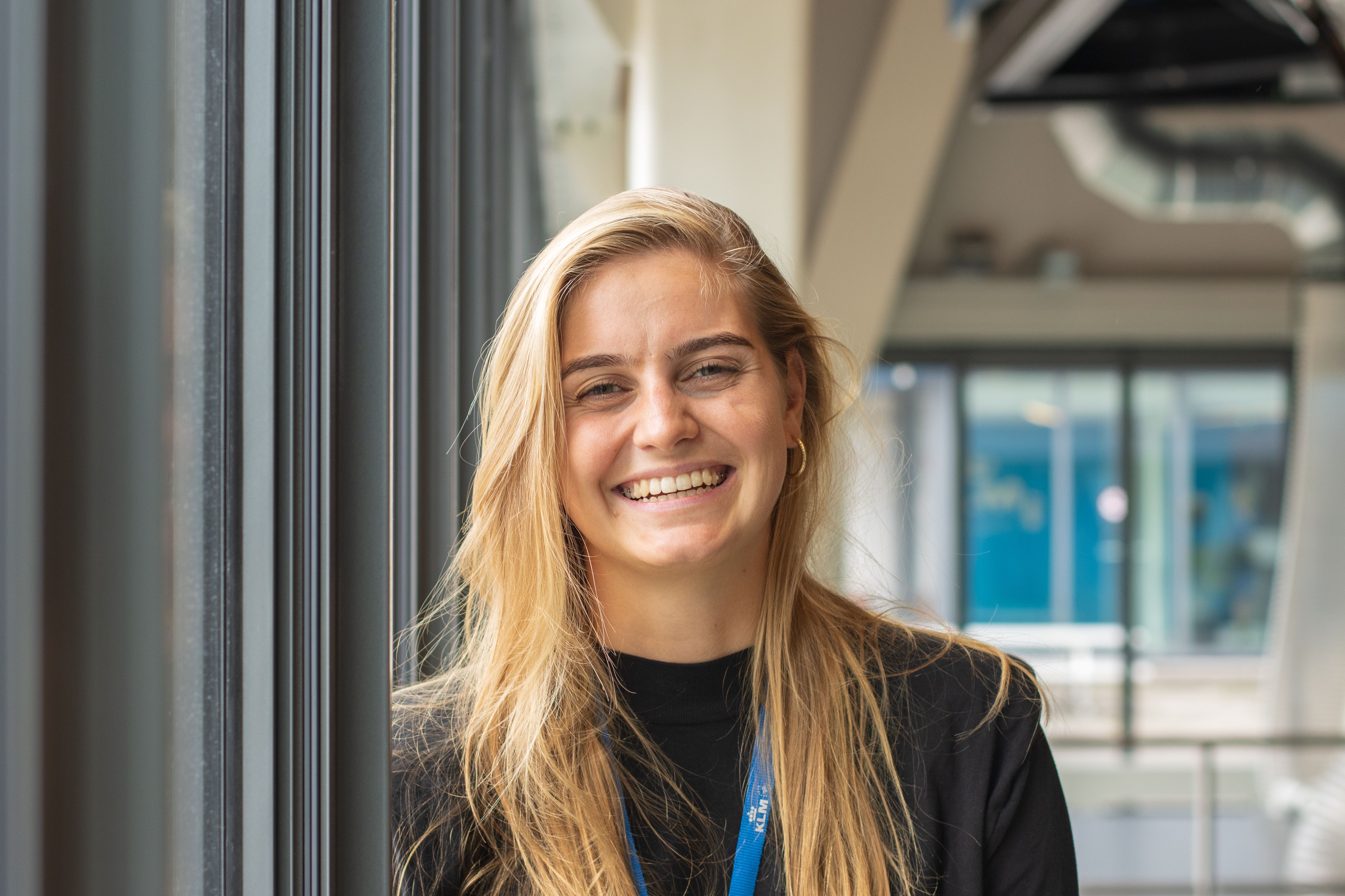 A KLM employee smiles at the camera