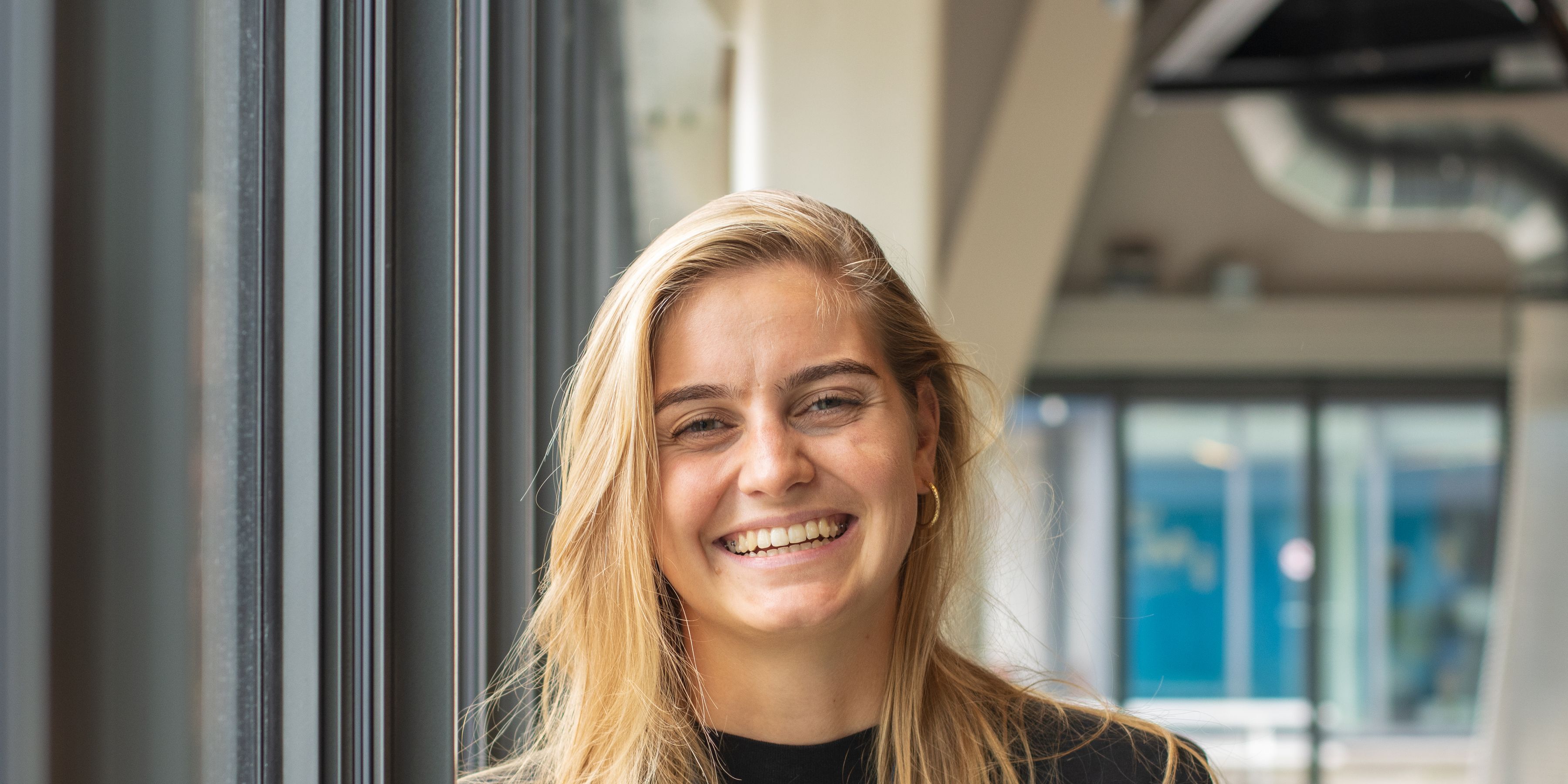 A KLM employee smiles at the camera
