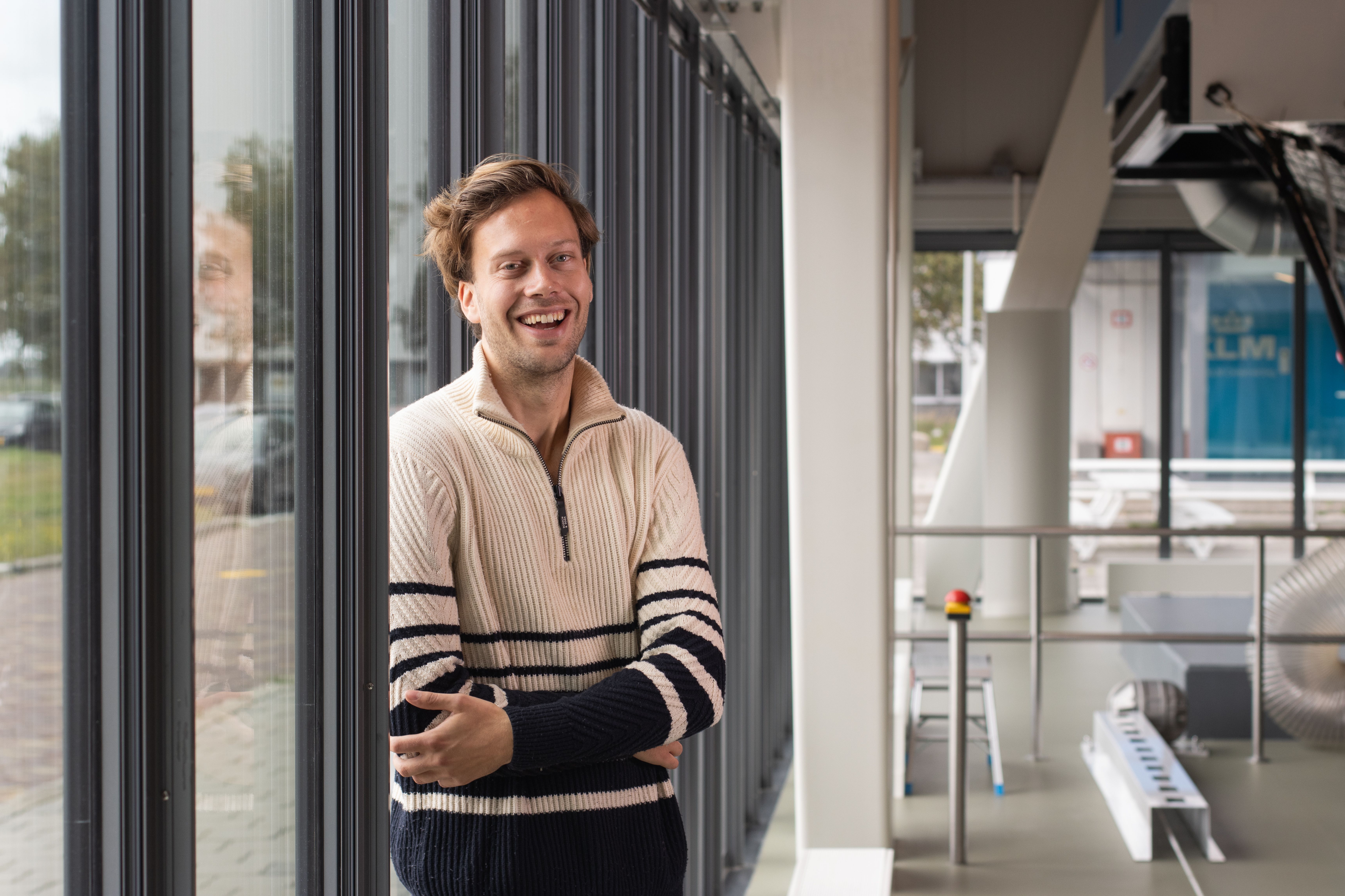 A KLM employee smiles at the camera