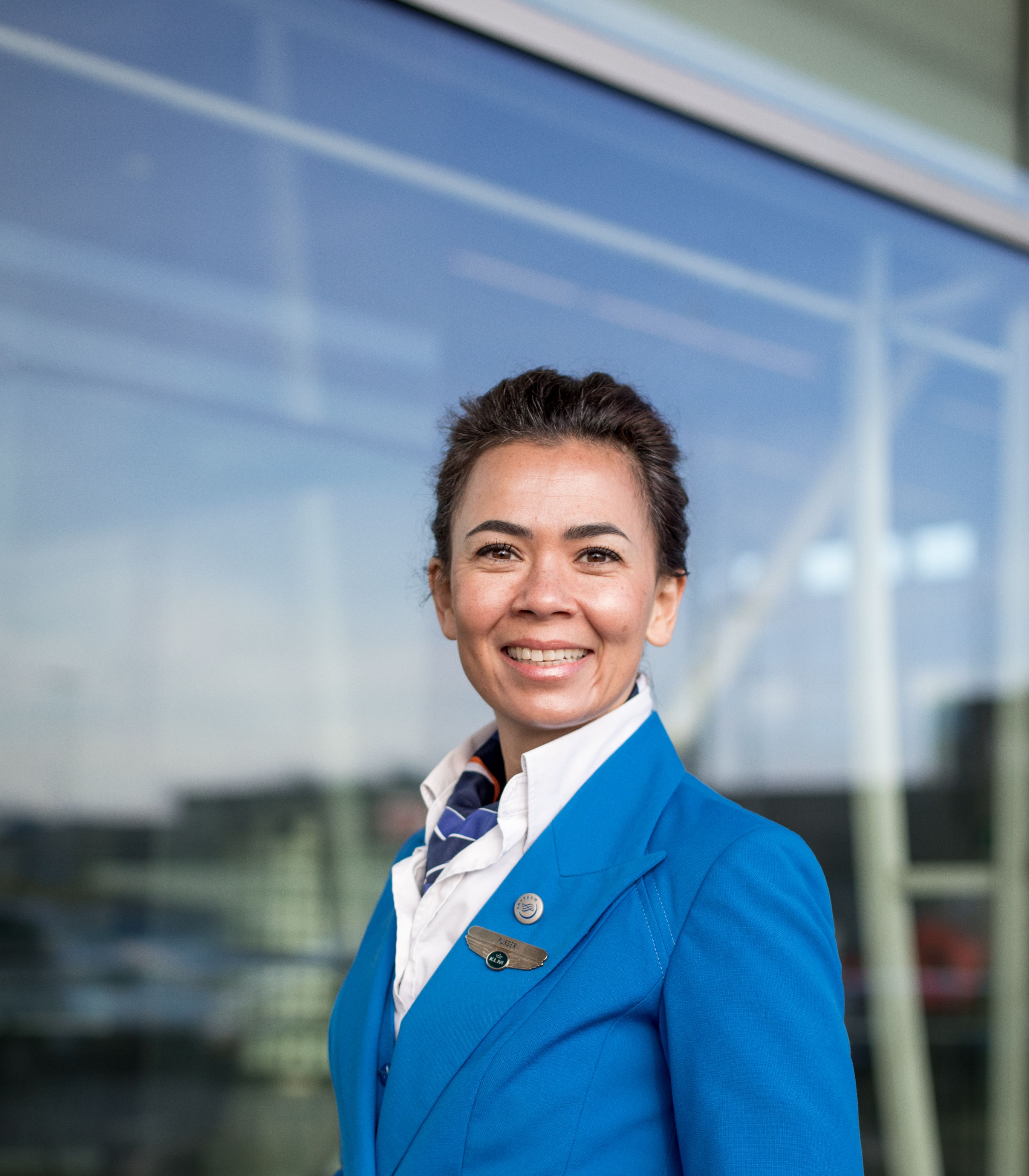 KLM Cabint attendant smiling and looking straight in the camera