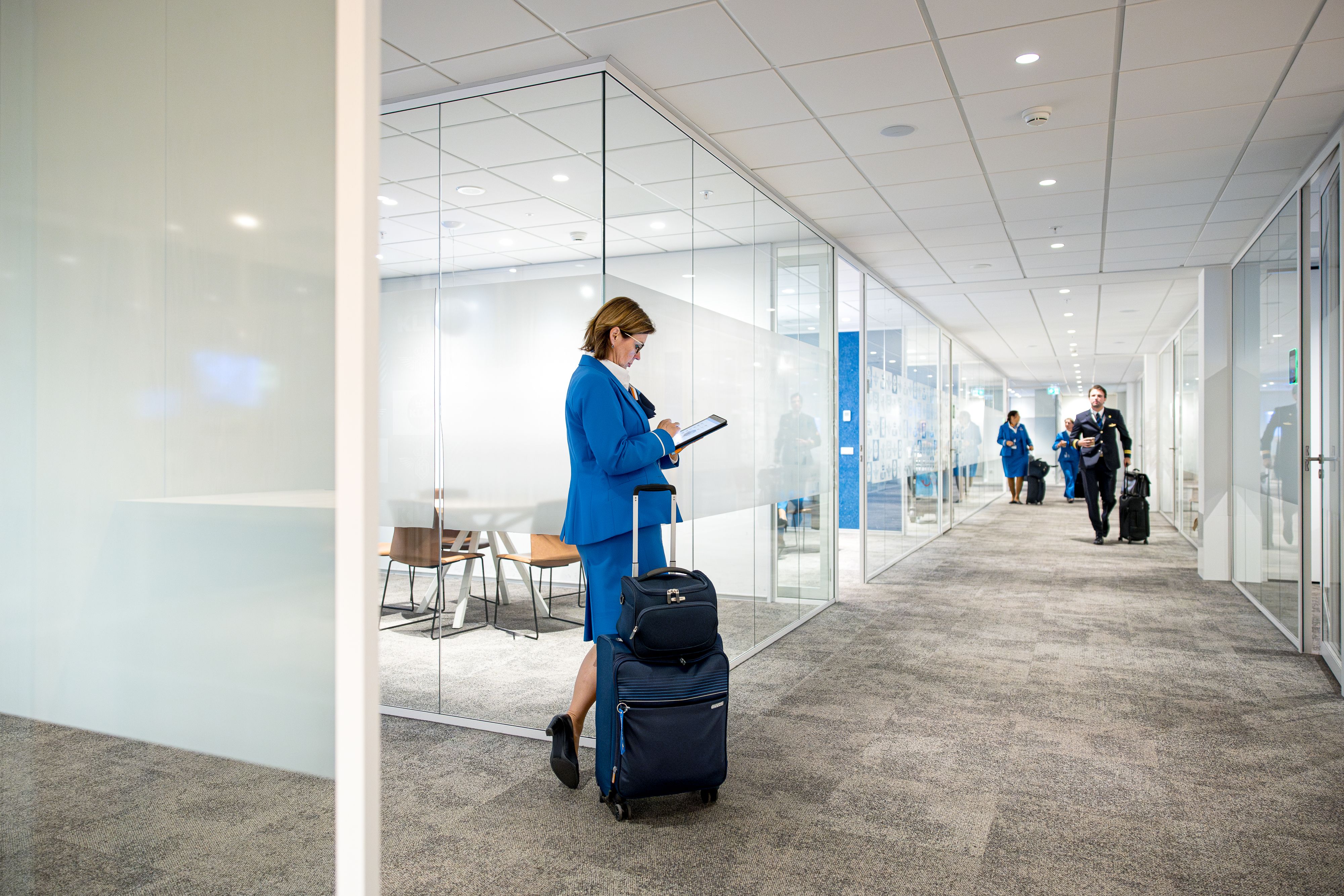 KLM Cabin Staff in the KLM Crew center checking her Ipad