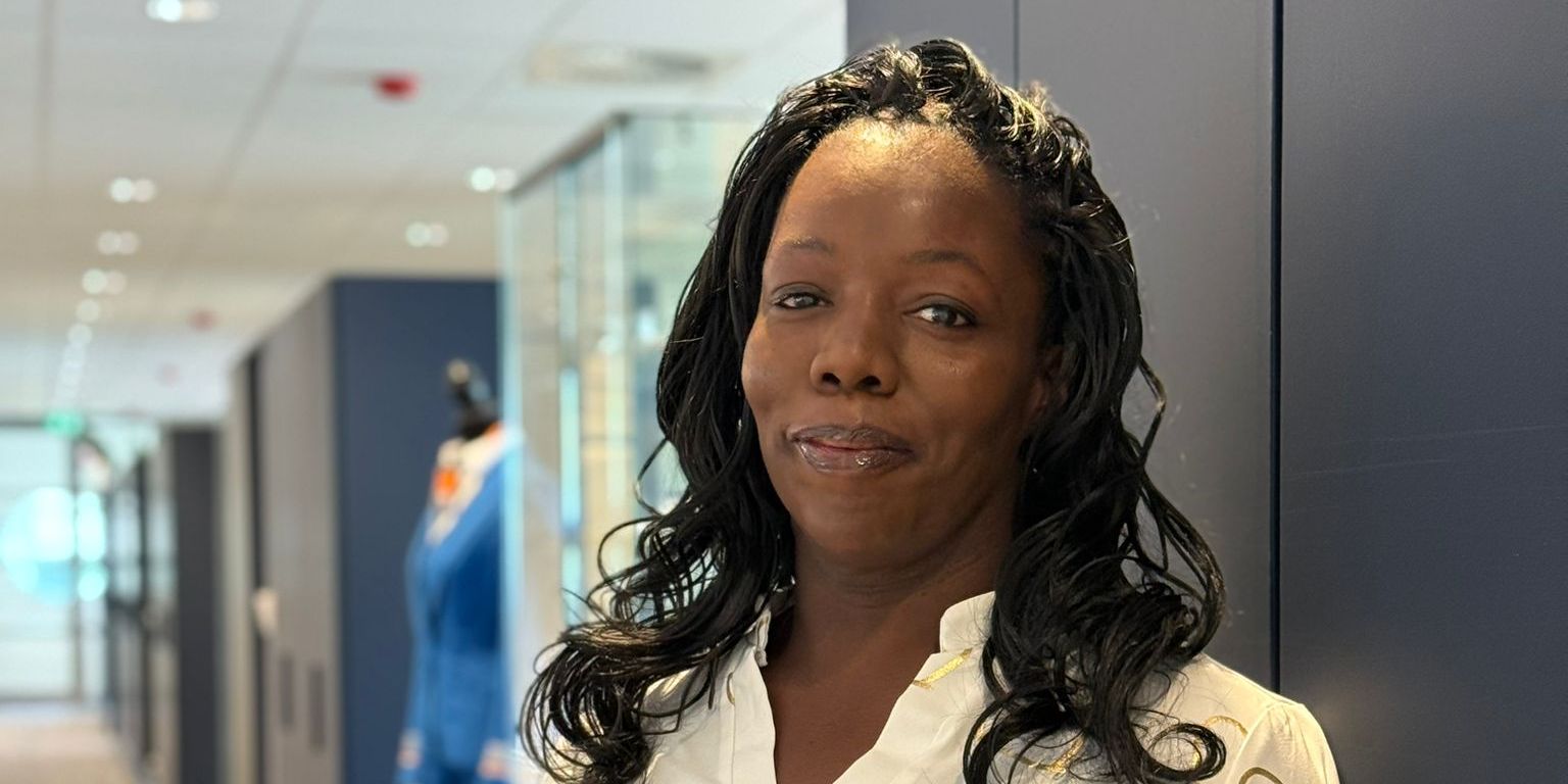 KLM colleague posing in a KLM office