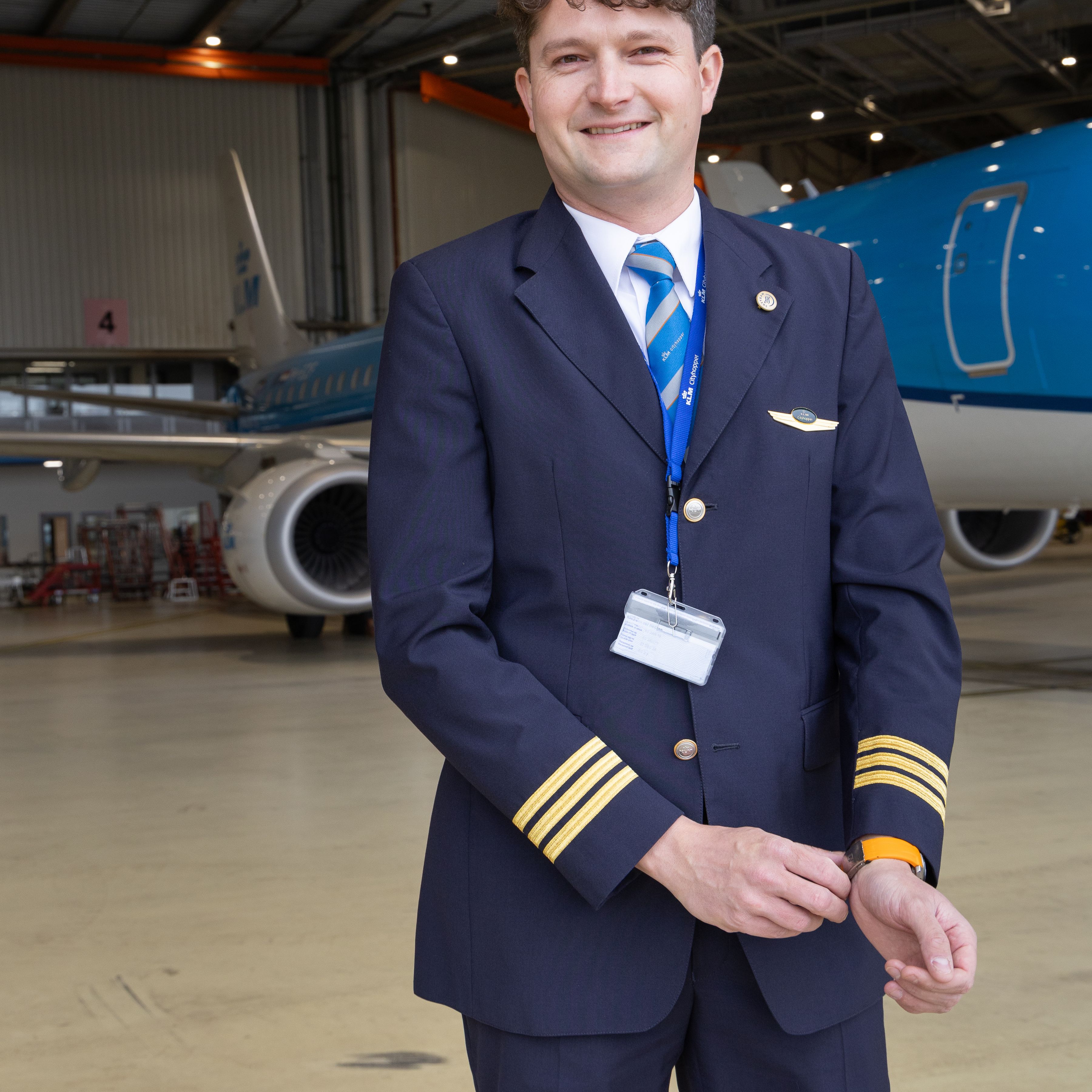 KLM Cityhopper pilot posing in a hanger