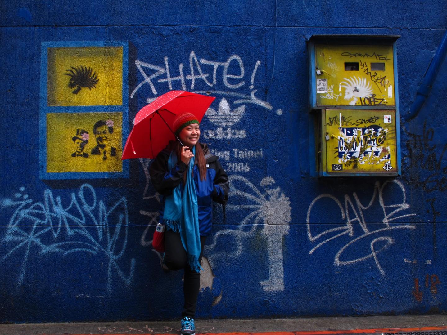 A blue wall with colorful graffiti in Ximending