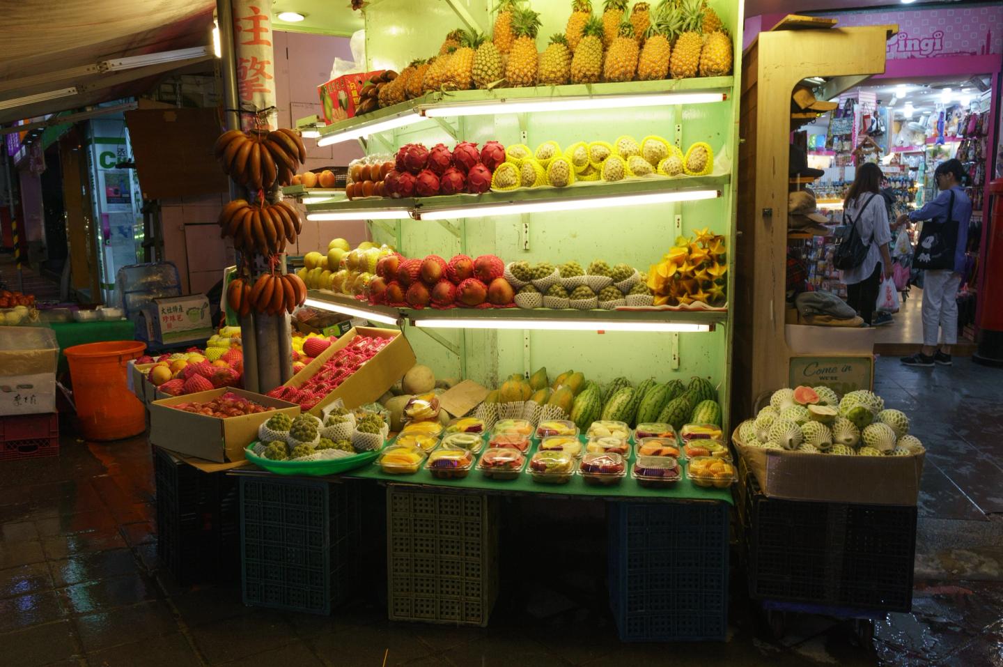 A brightly lit fruit shop on a Ximending street