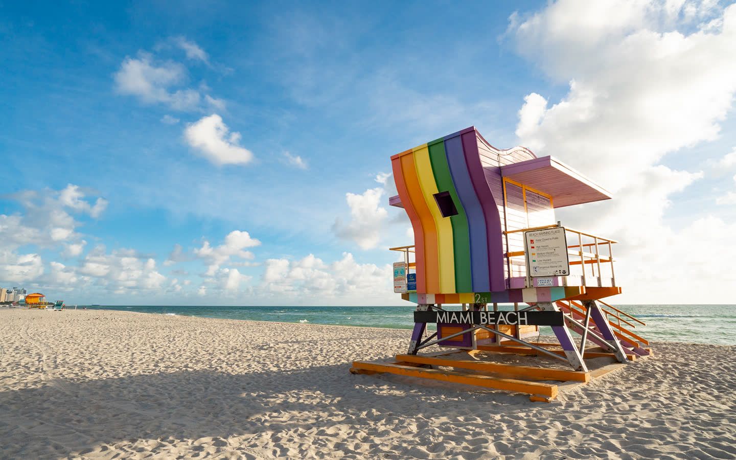 Rainbow Miami Beach lifeguard stand on the sand at the LGBTQ beach