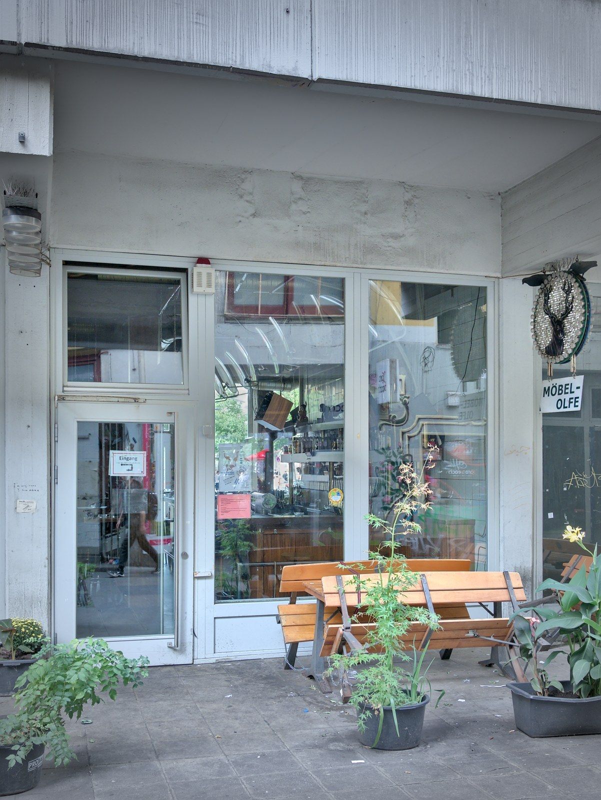 Möbel Olfe entrance with MÖBEL-OLFE stag-head sign and glass storefront