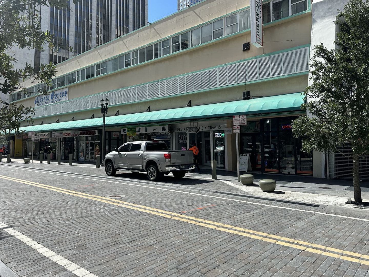 Flagler Street shopfronts in downtown Miami, including Optica Cortes