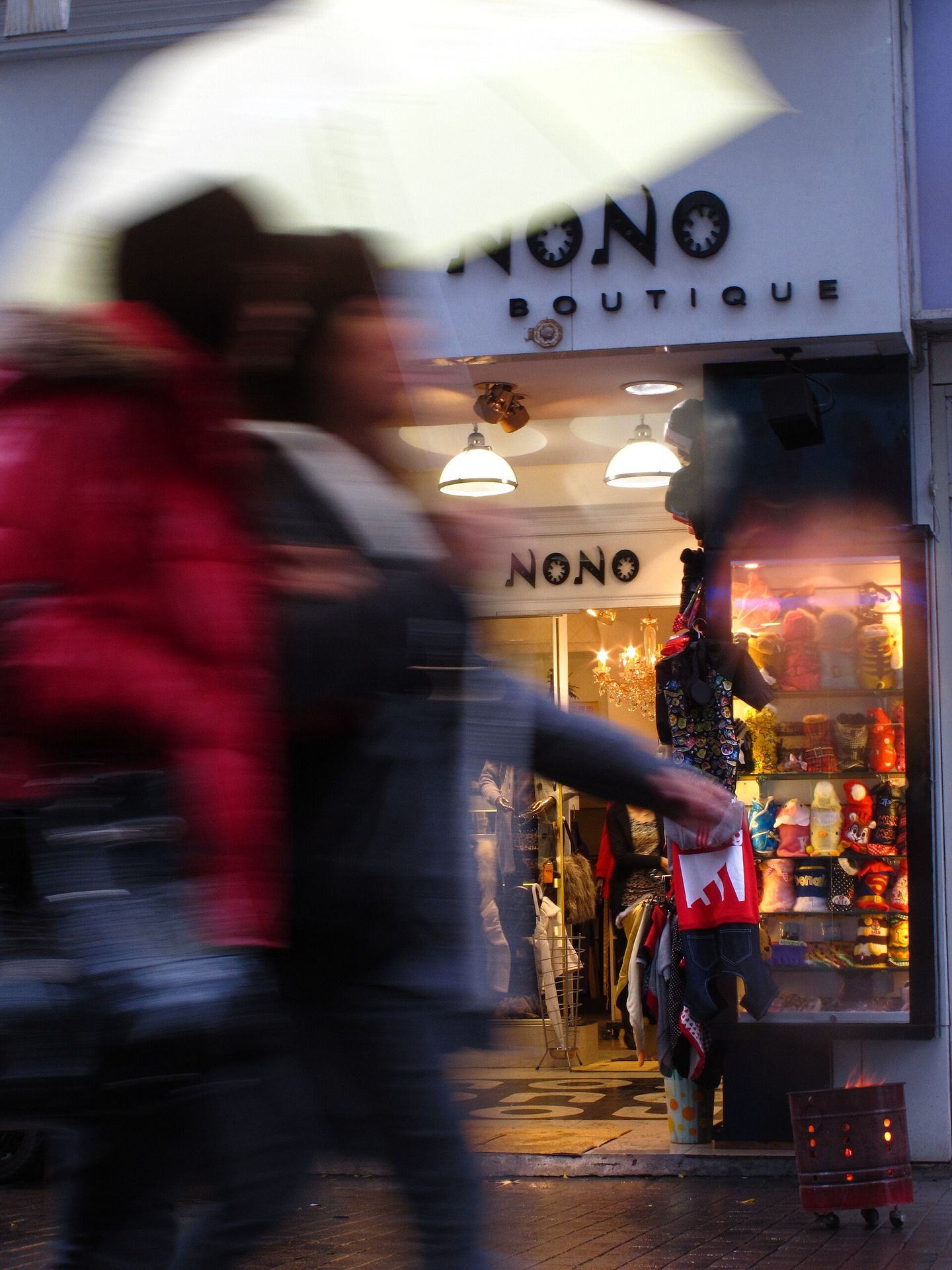 Pedestrians passing a shopfront in Ximending