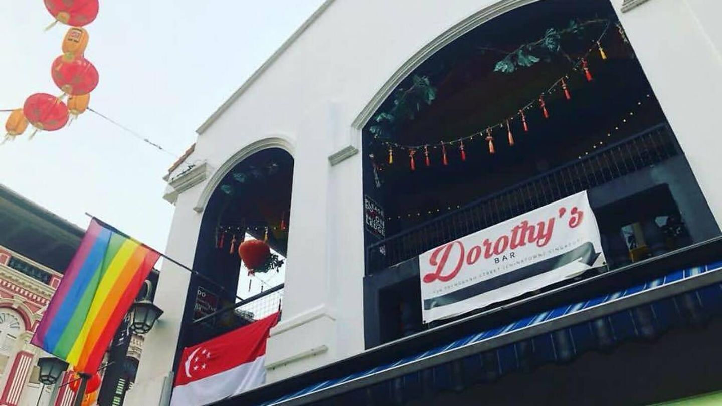 Dorothy’s Bar exterior with rainbow and Singapore flags in Chinatown