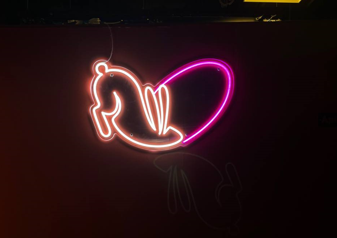 Neon Rabbit’s Hole logo inside the Singapore nightclub