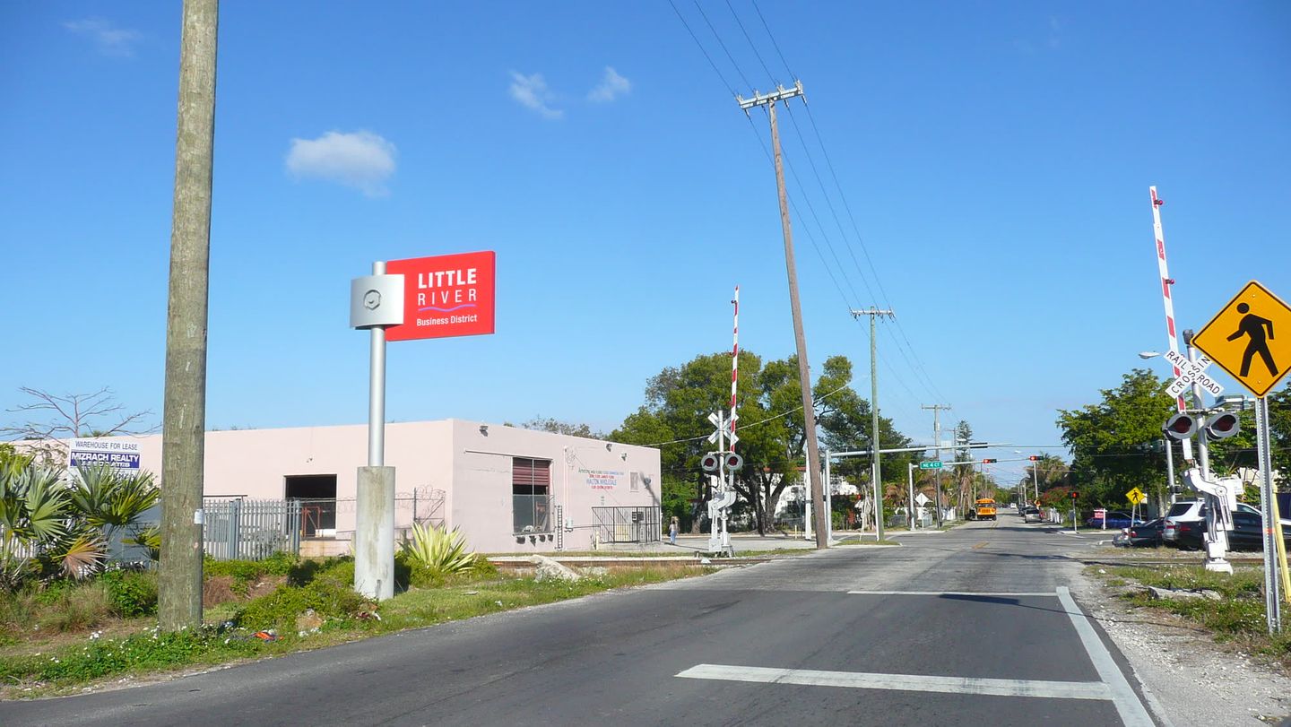 LITTLE RIVER Business District sign at a railroad crossing