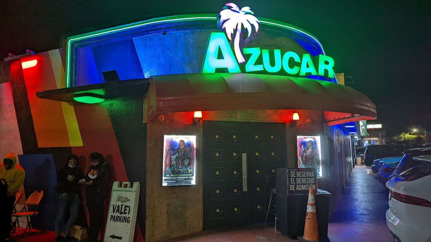 Azucar Nightclub night facade with AZUCAR neon and palm-tree sign