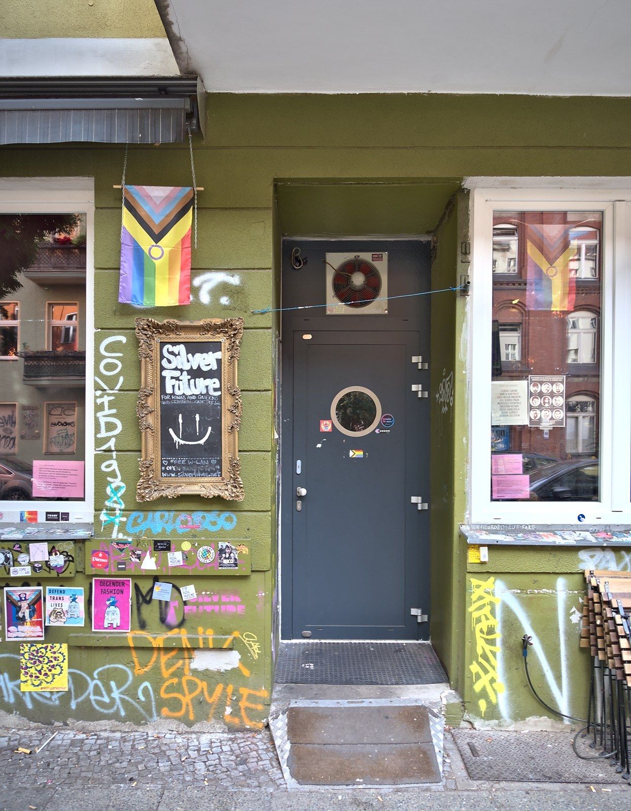 Silverfuture bar entrance on Weserstraße with framed sign and Progress Pride flag
