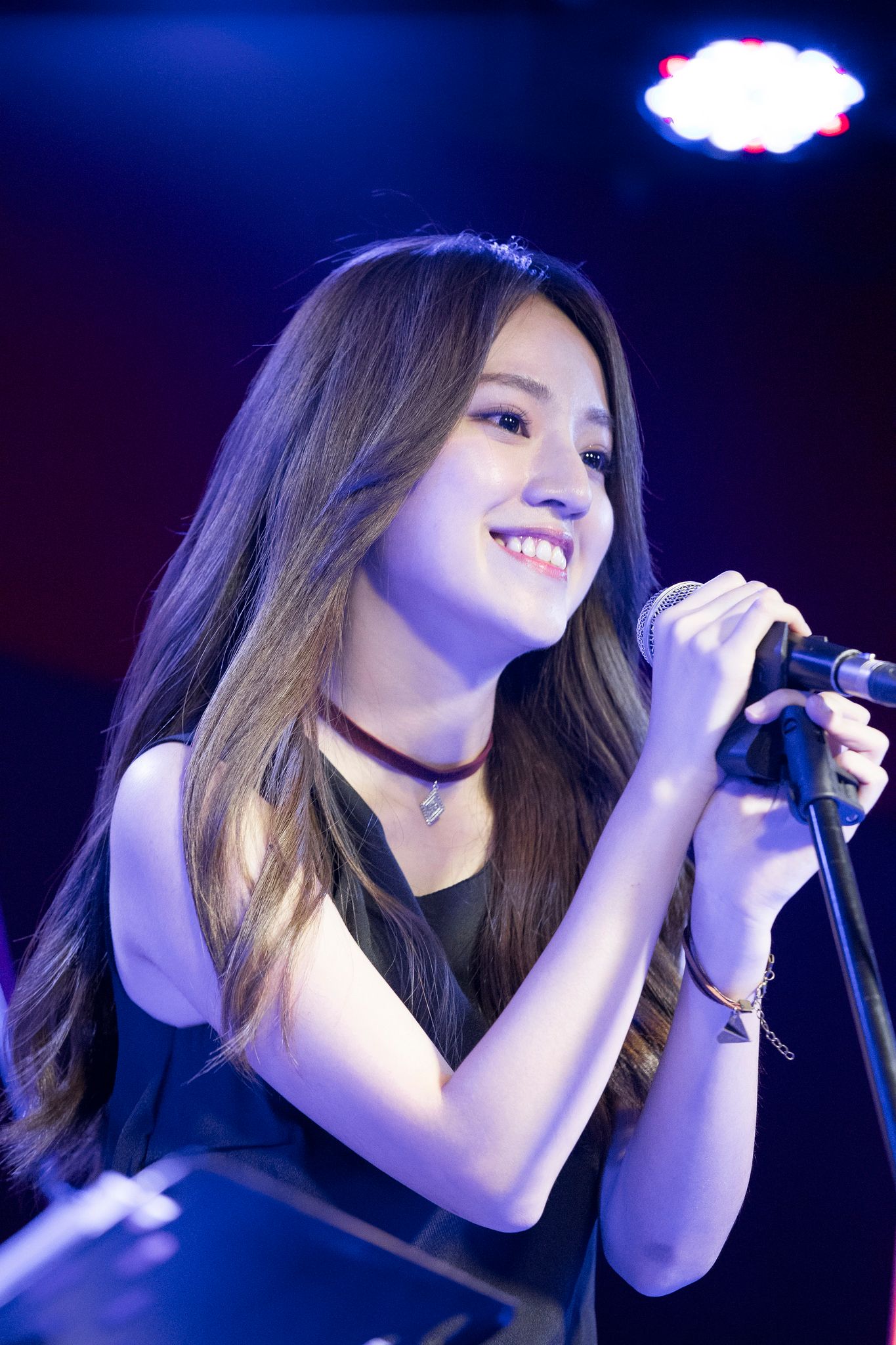 A singer performing on a small live-music stage in Gongguan