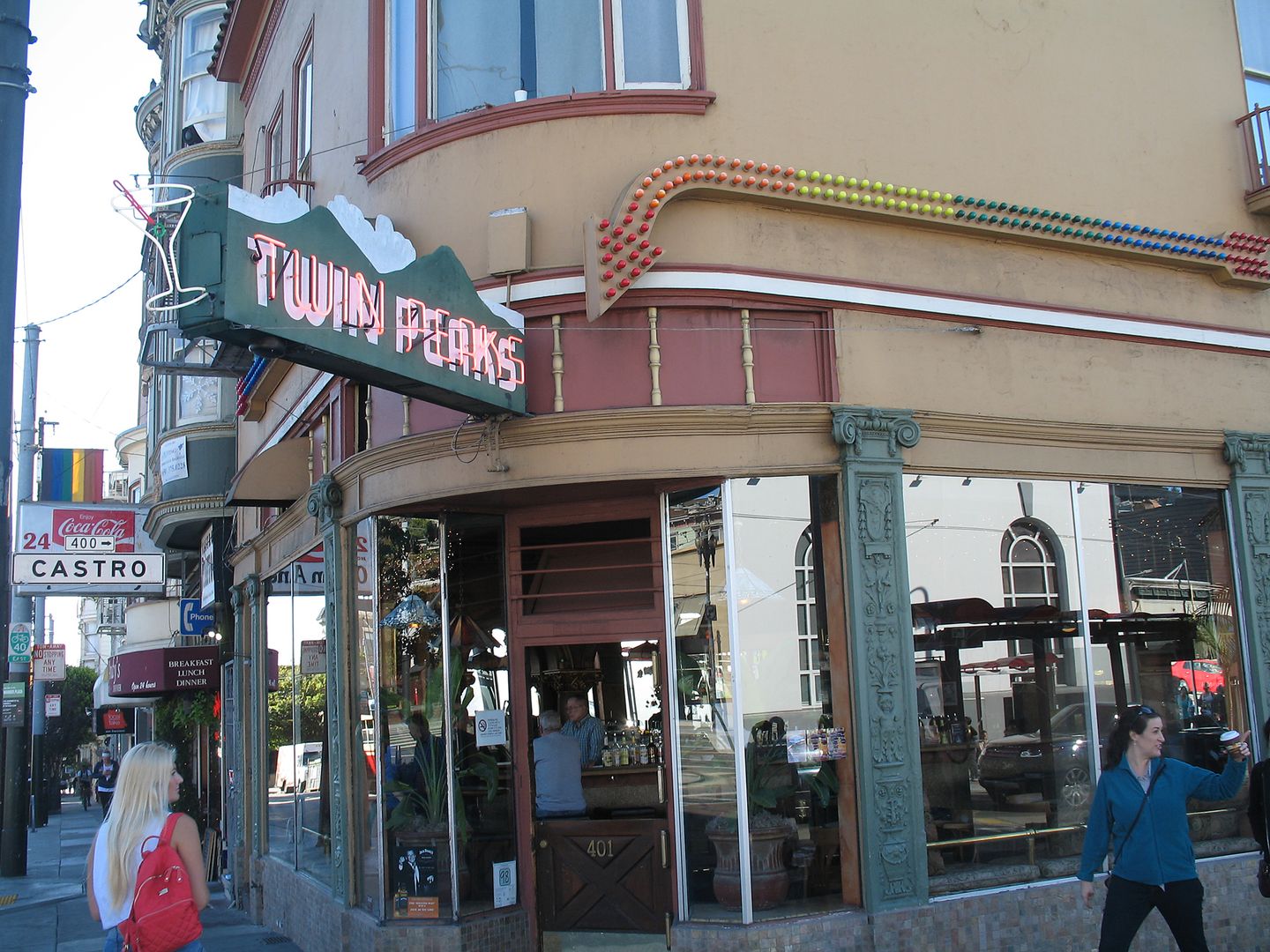 The Twin Peaks Tavern corner at 401 Castro Street, with the mountain-shaped sign, plate-glass windows, and the Castro street sign