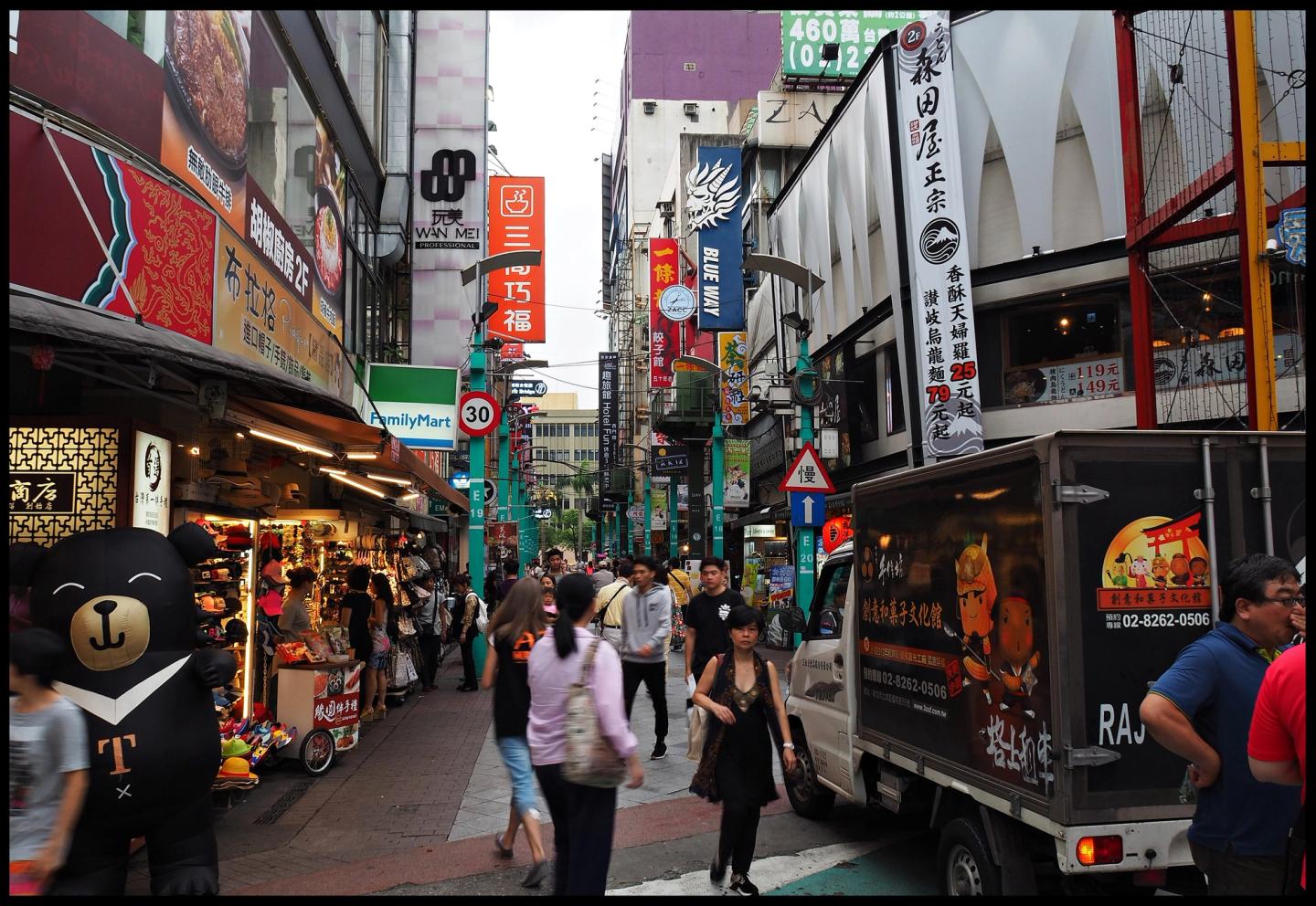 A broad view of shops and people in Ximending