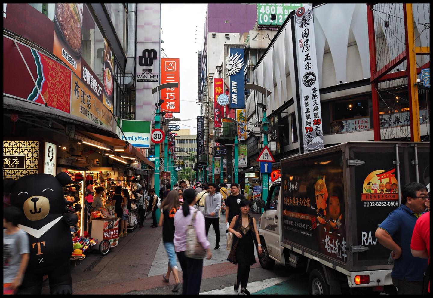 A broad view of shops and people in Ximending