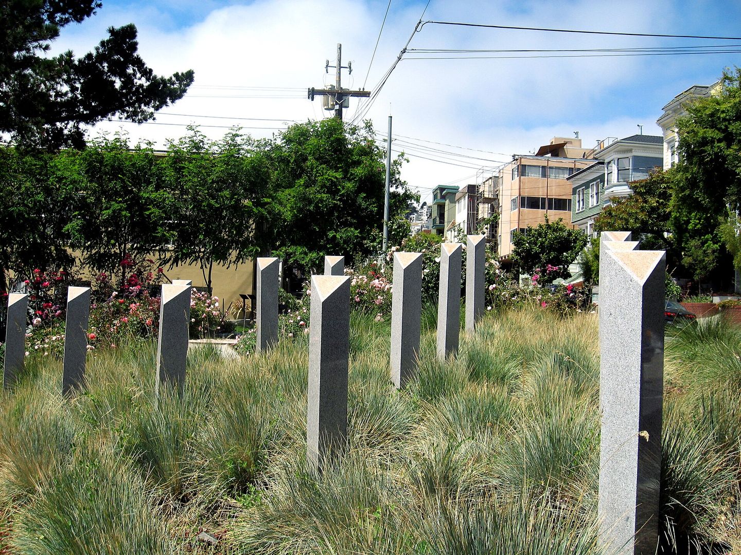 Granite memorial posts and ornamental grasses at Pink Triangle Park in the Castro