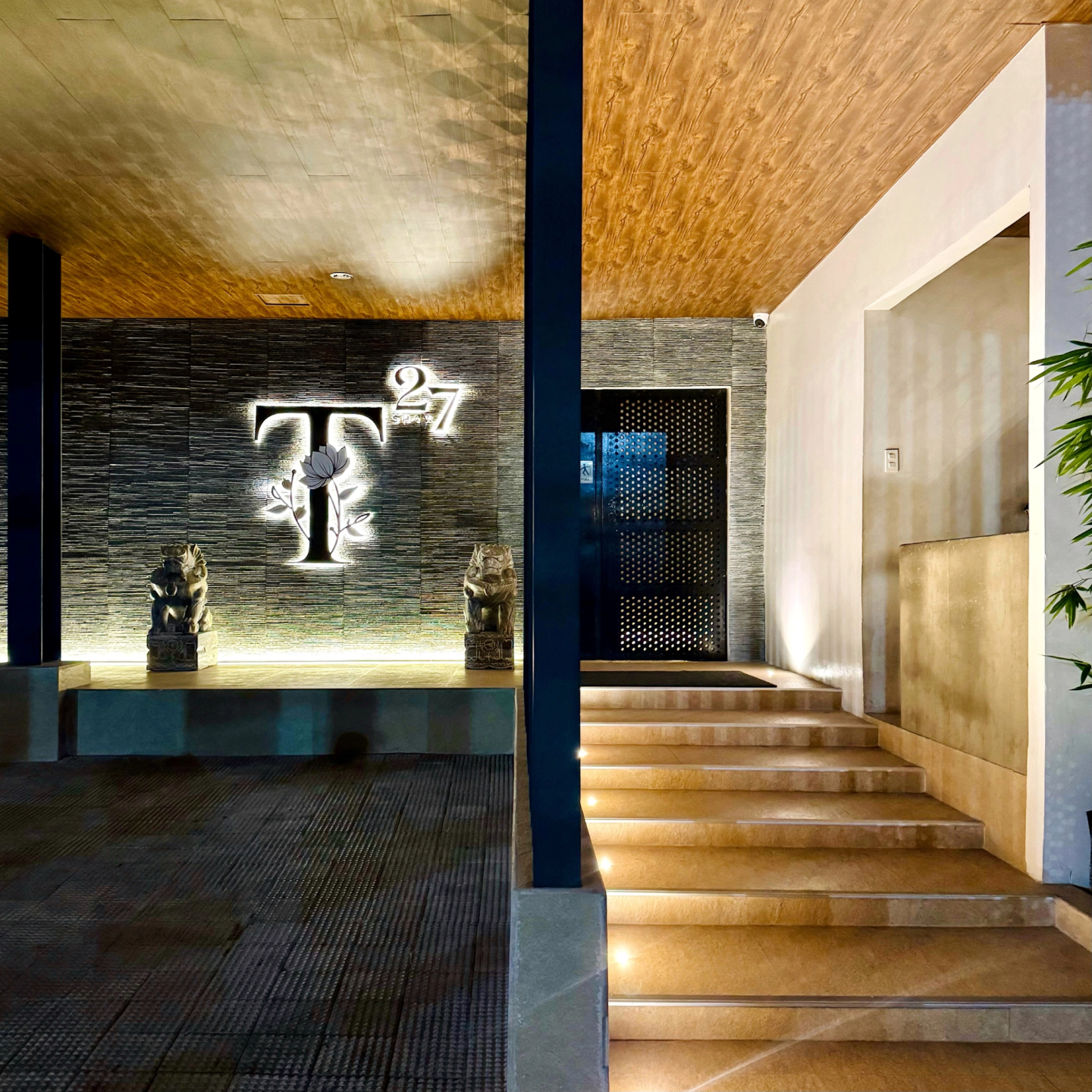Lit entrance and T by 27Shaw venue sign in Quezon City