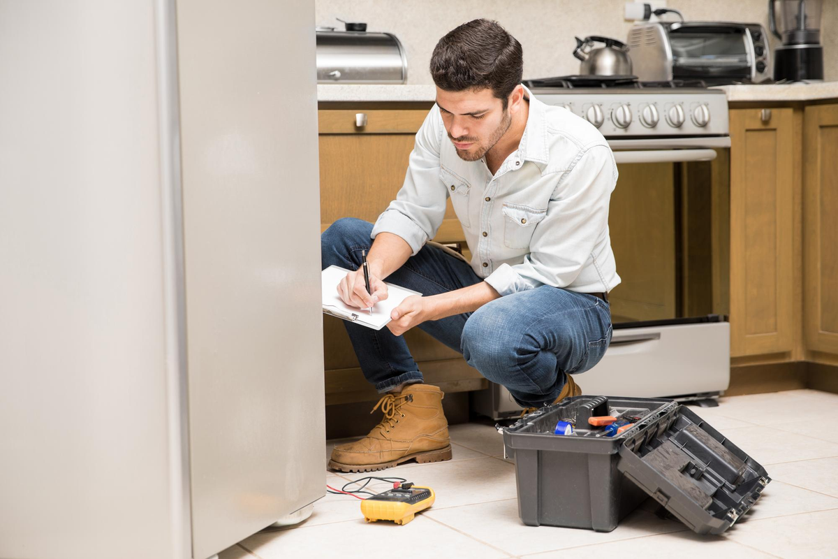 technician-inspecting-refrigerator