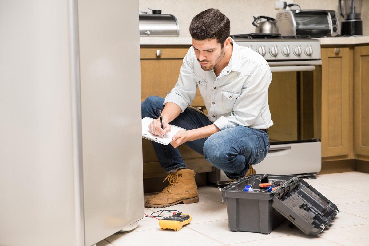 technician-inspecting-refrigerator