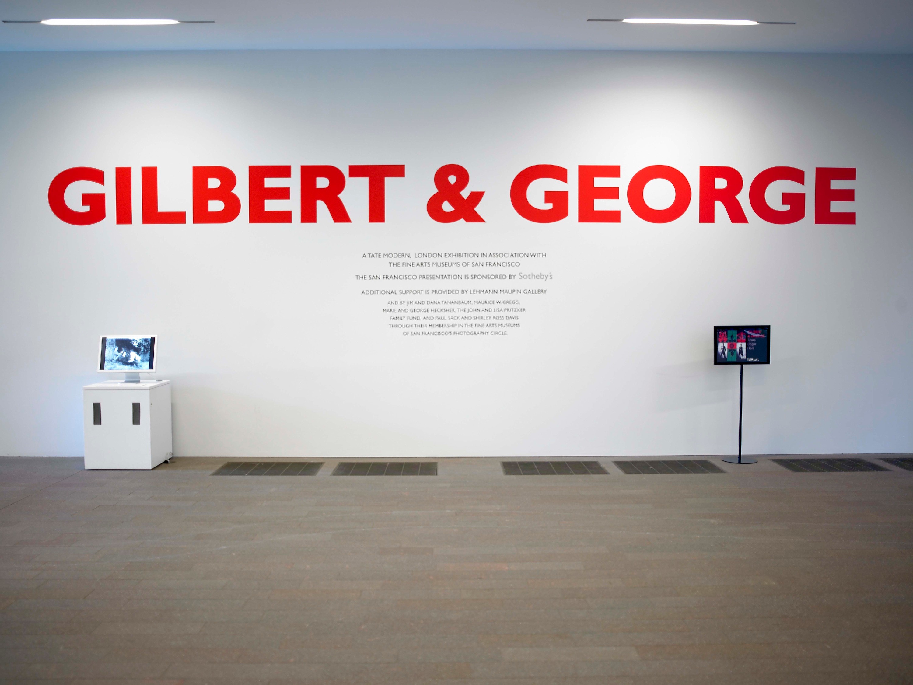 Installation view of Gilbert & George: Major Exhibition at de Young Fine Arts Museum