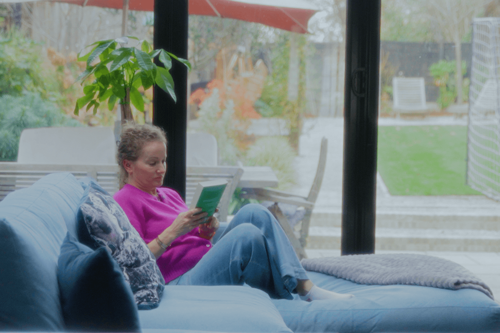Beckenham home interiors living space with blue sofa and garden view creating a calm reading area