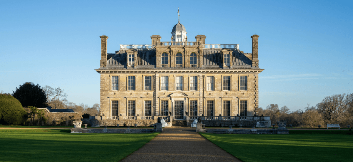 Home stewardship example with stately home, maintained grounds and symmetrical exterior design