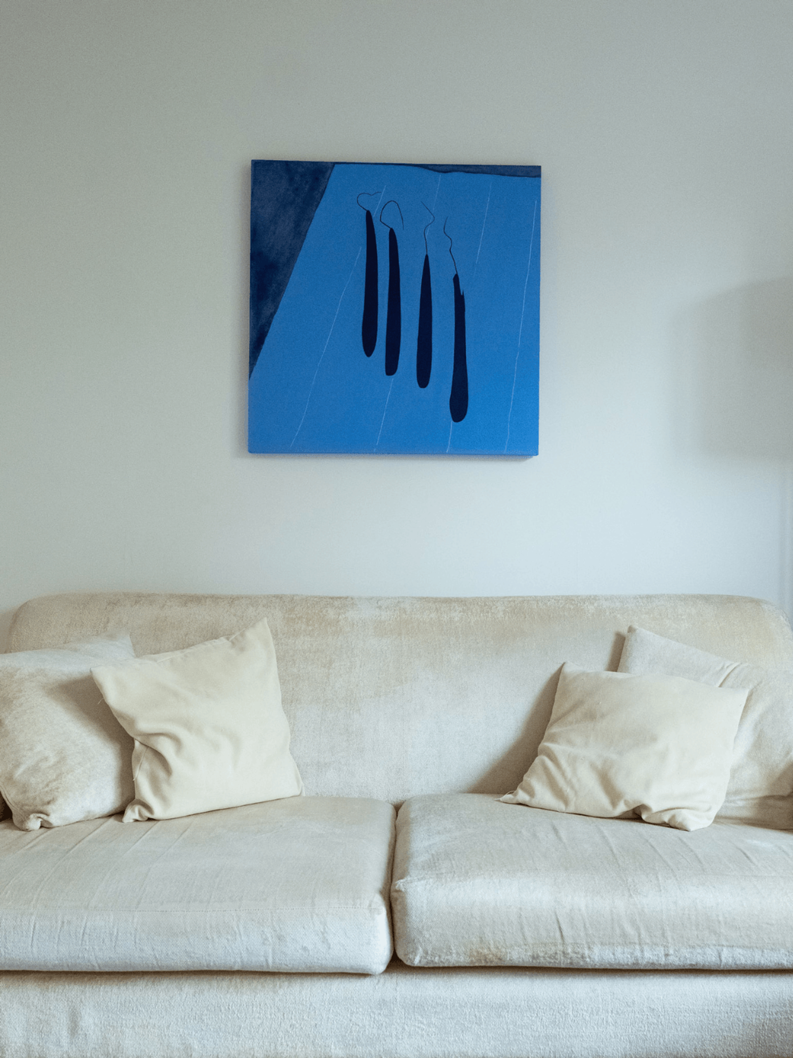 Sevenoaks interior design living space with blue abstract painting above neutral sofa