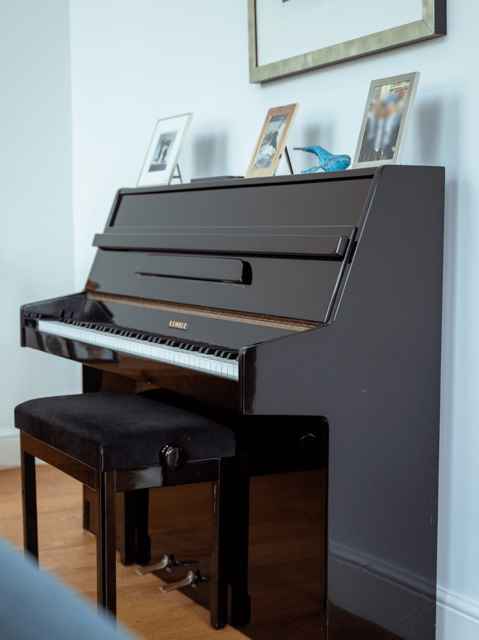 Kent home interiors upright piano styled with framed photographs in a contemporary living space