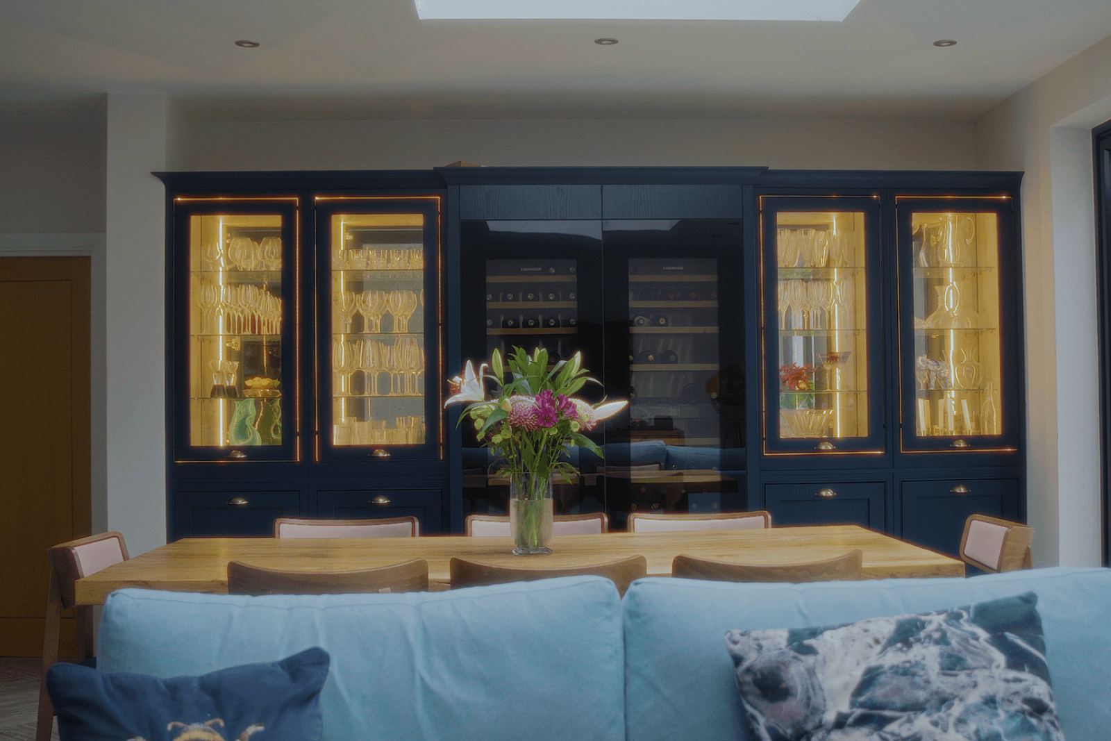 Beckenham home interiors dining area with bespoke cabinetry and illuminated glass display units