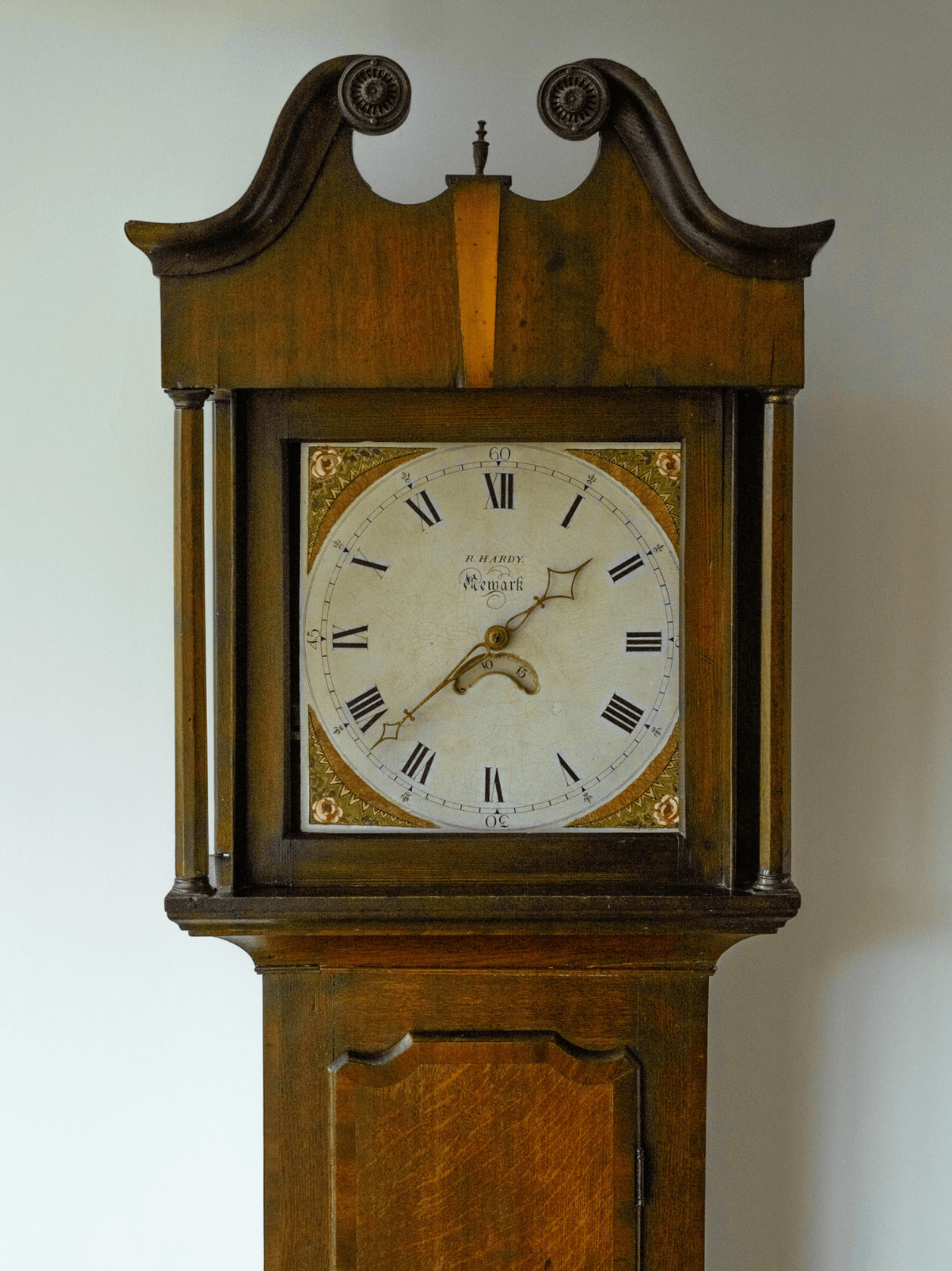 Kent home interiors detail of antique longcase clock dial with Roman numerals and painted face