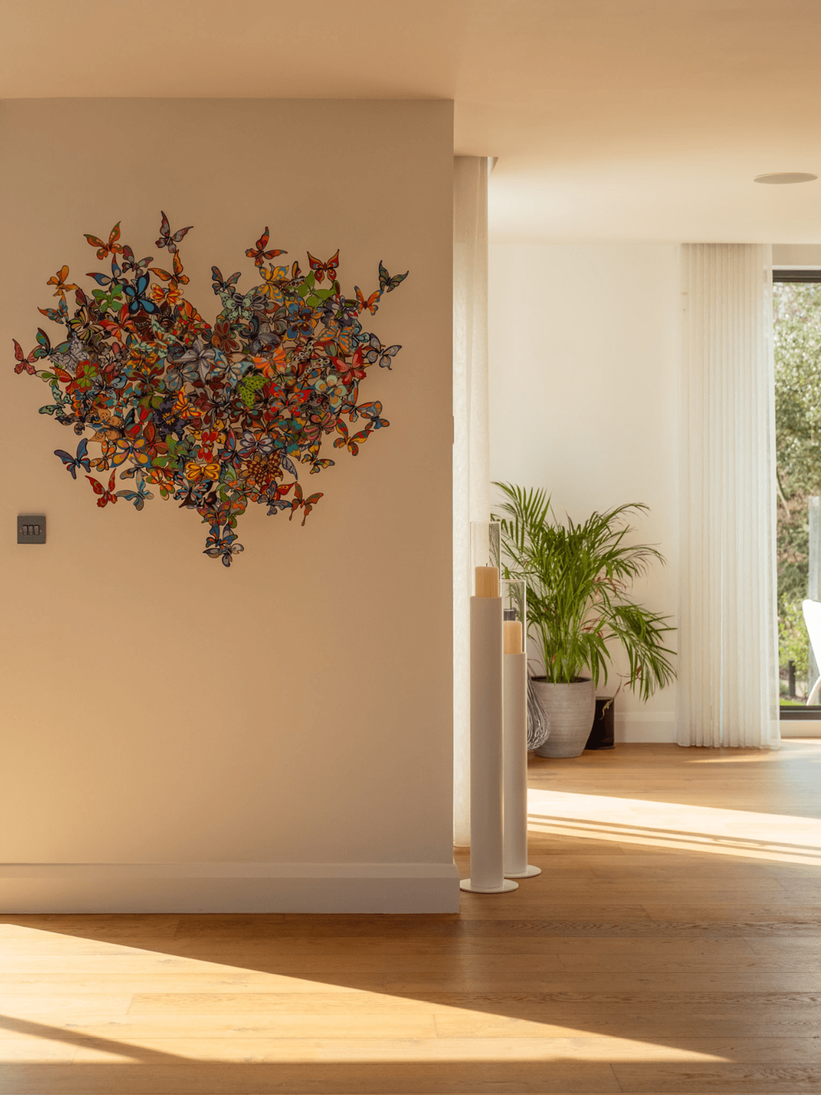 Sevenoaks interior design with colourful butterfly wall artwork in a bright open-plan living space