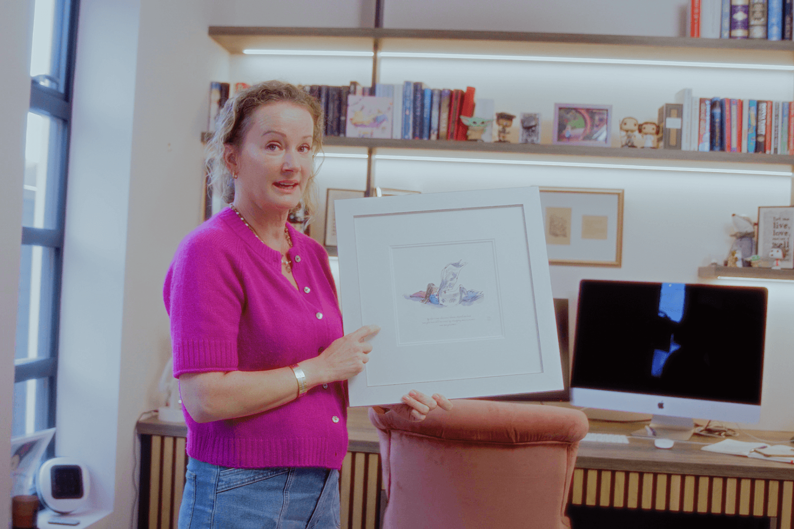 Beckenham home interiors home office with Katherine holding framed artwork in bespoke workspace