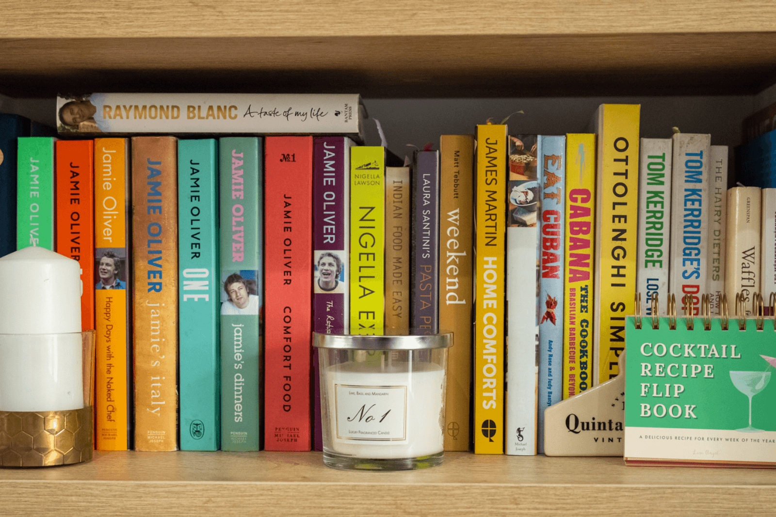Kent home interiors close-up of colourful cookbook shelf with Jamie Oliver, Ottolenghi and Nigella Lawson books