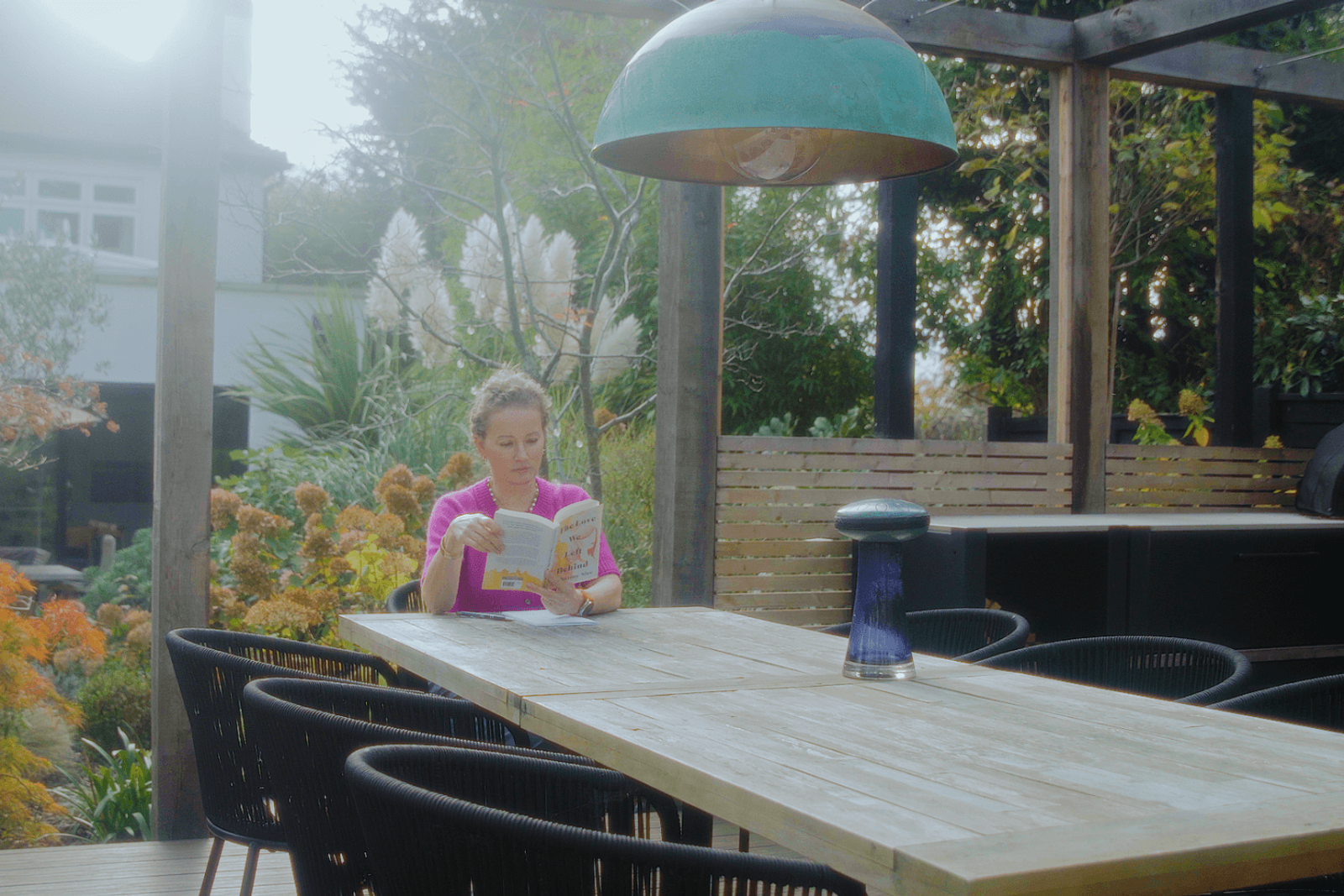 Beckenham outdoor kitchen and dining area with timber pergola and garden planting