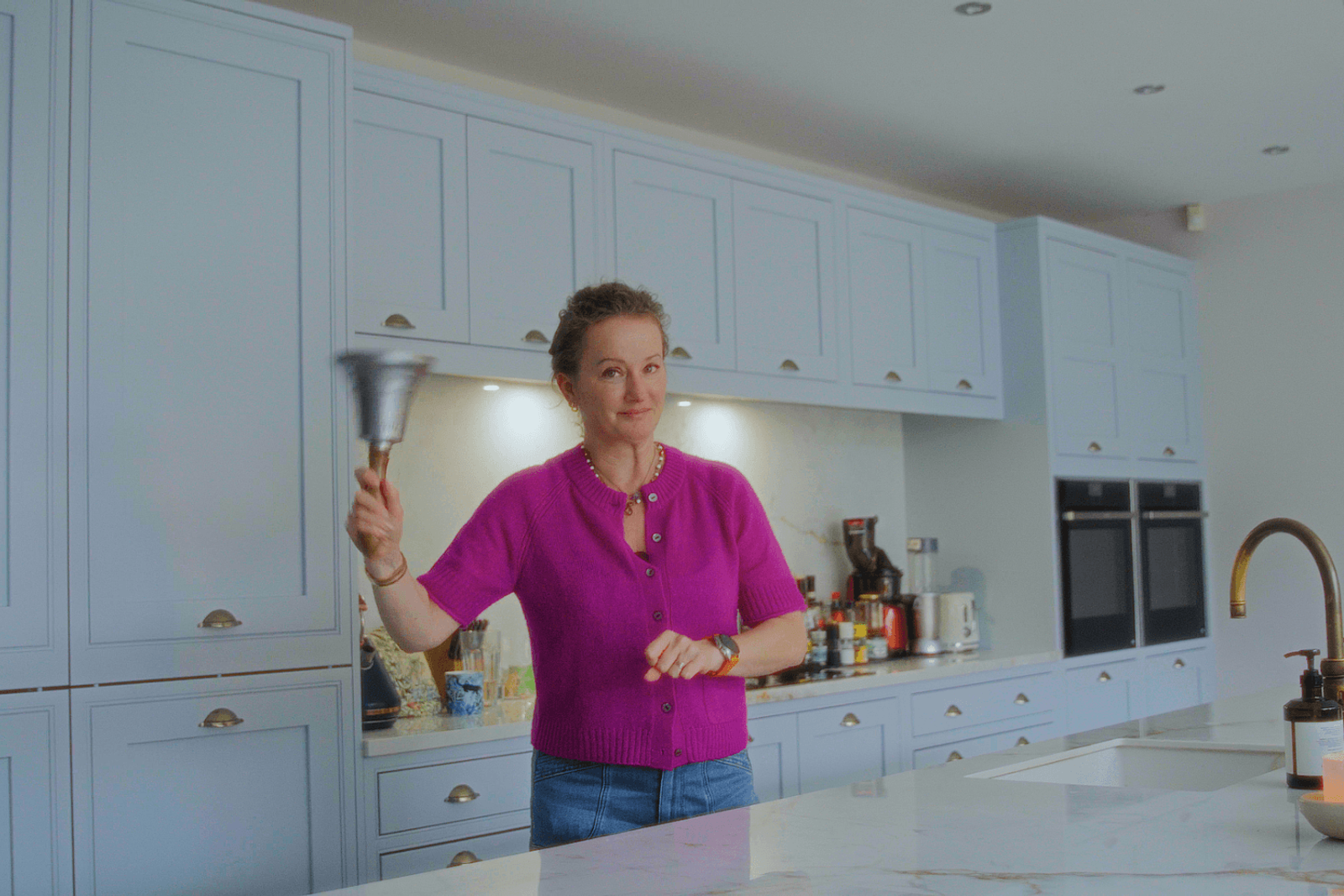 Beckenham home interiors kitchen cabinetry with brass handles and island space in use