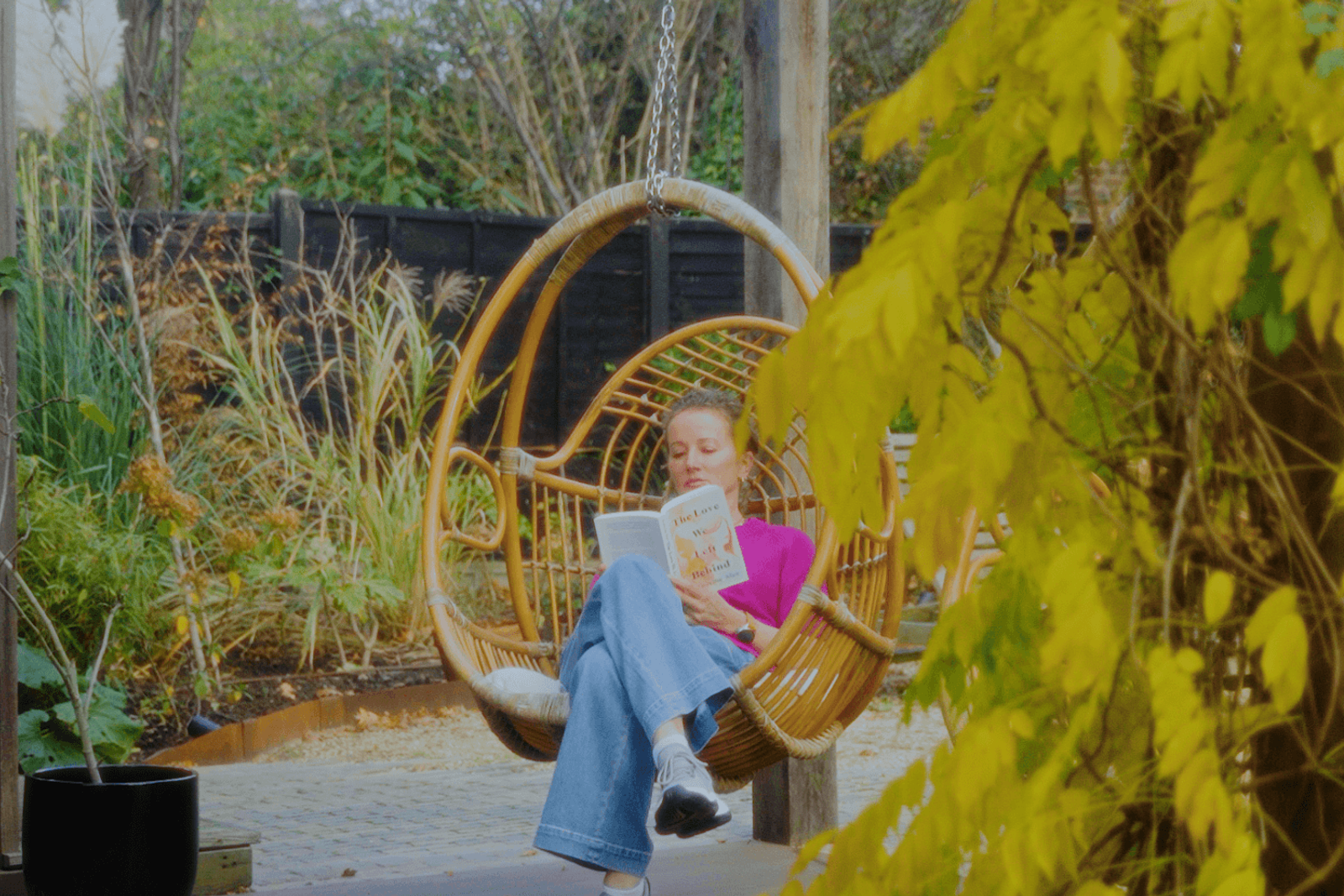 Beckenham garden seating area with hanging chair and layered planting for outdoor living